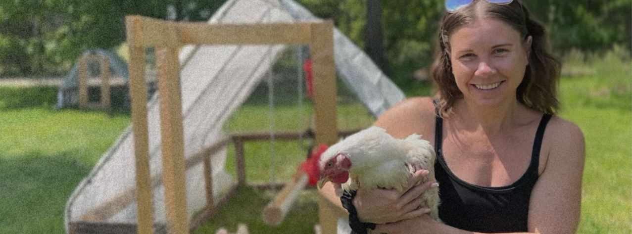Paige with one of our pasture raised birds, clearly thrilled about being picked up.