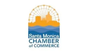 Logo of Santa Monica Chamber of Commerce with a Ferris wheel, a building silhouette, a water body, and text