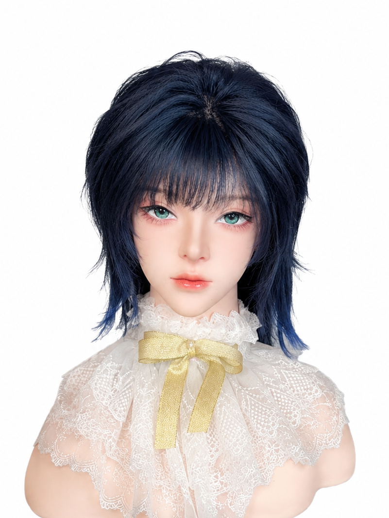 Close-up of a doll with pale skin, long dark blue hair, and striking green eyes, wearing a lace dress with a gold ribbon bow.