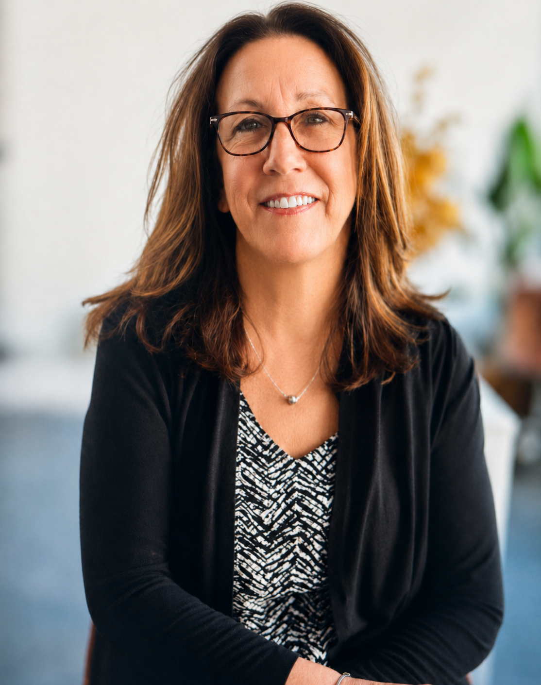 Donna Jutras, owner of 603 Polished Interiors, smiling in a black cardigan