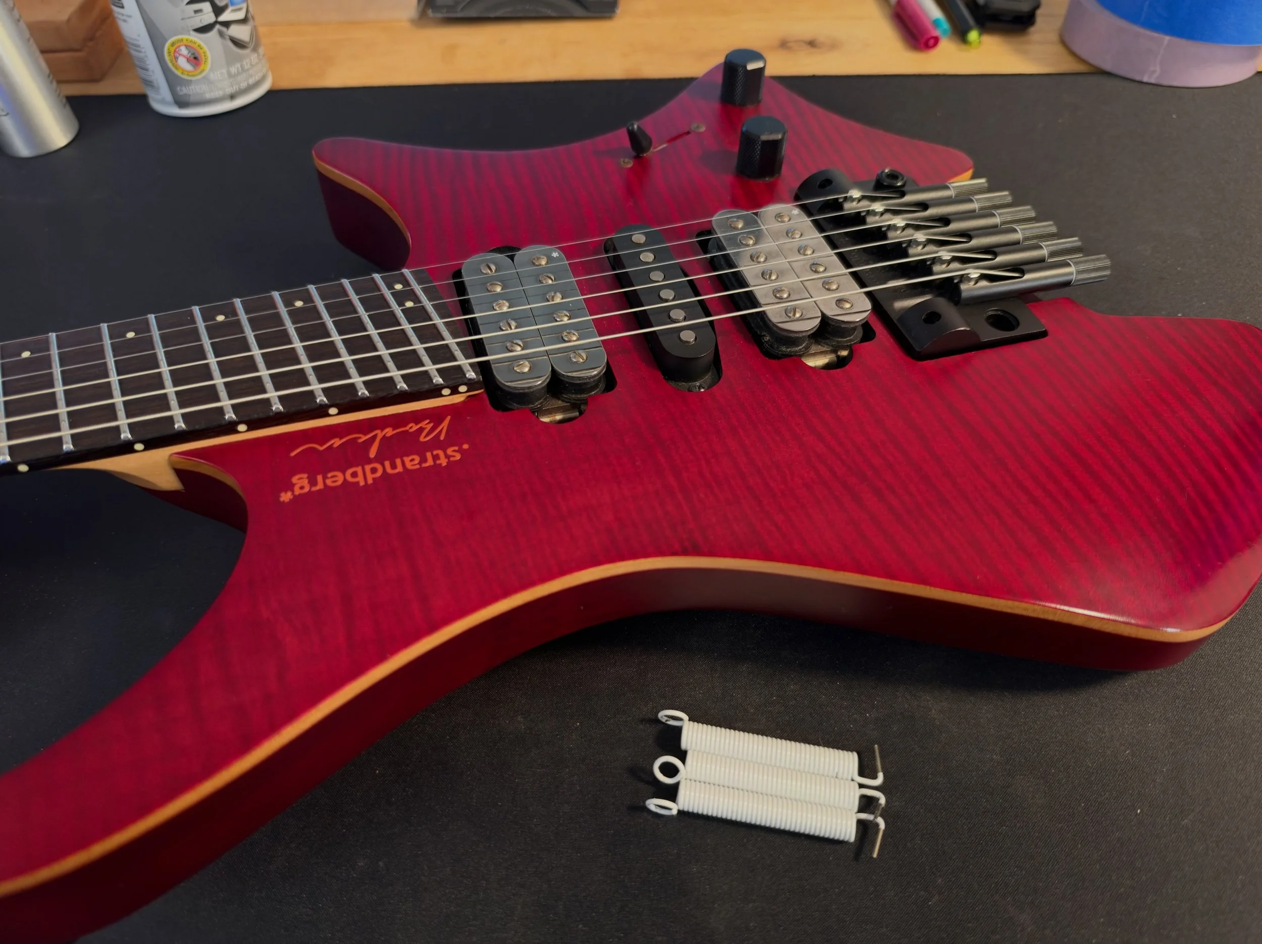 The Strandberg Fusion Machacek is back on the bench. I put in some @futone white springs in it last string change and have loved them, but their springy-ness made it difficult to tune a headless guitar at the bridge. Strings changed today, and instal