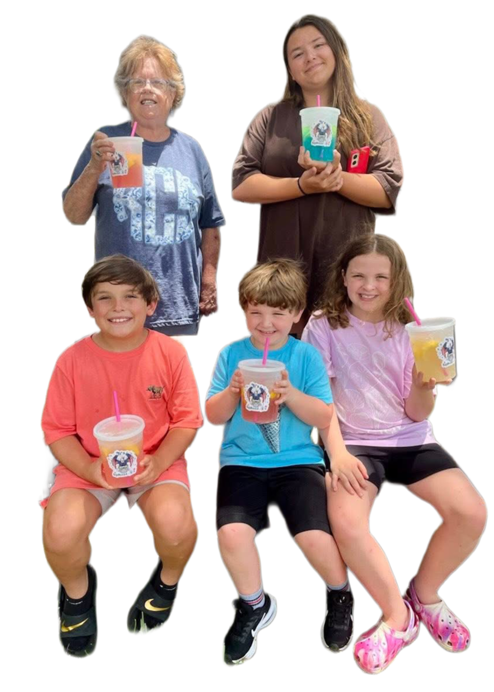 Group of five children and two adults holding colorful drinks with pink straws, smiling, on a white background.