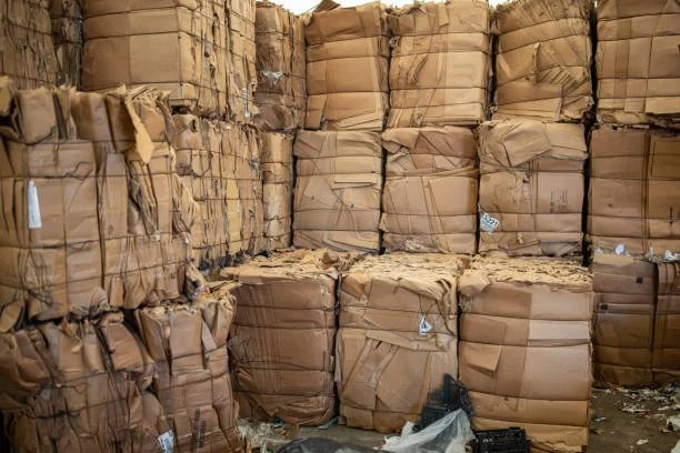 Stacks of brown paper packages in a storage room or warehouse.