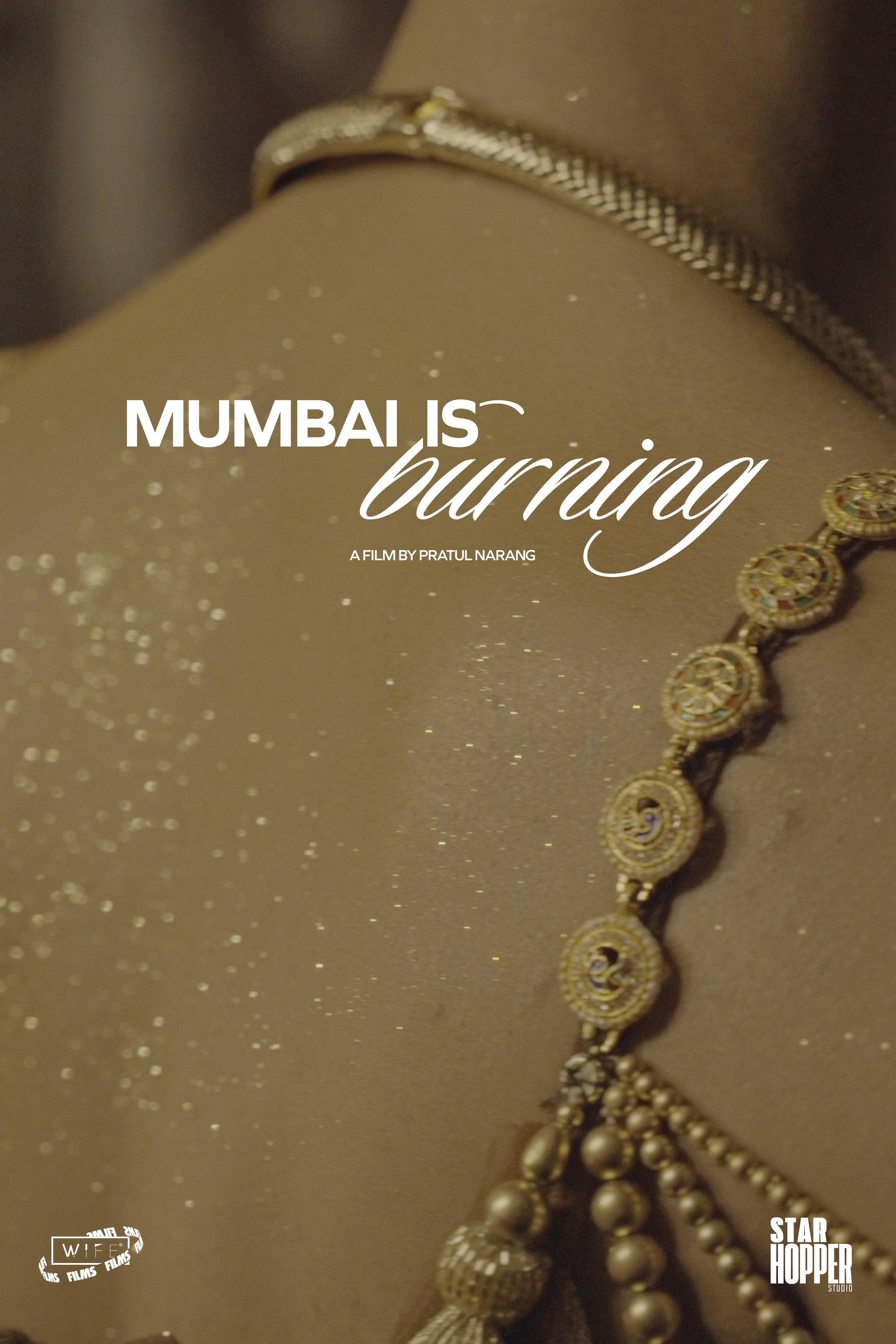 Close-up of gold jewelry, including a necklace and a ring, with the text 'Mumbai is burning' overlayed, and logos for 'Wife Films' and 'Star Hopper Studio'.