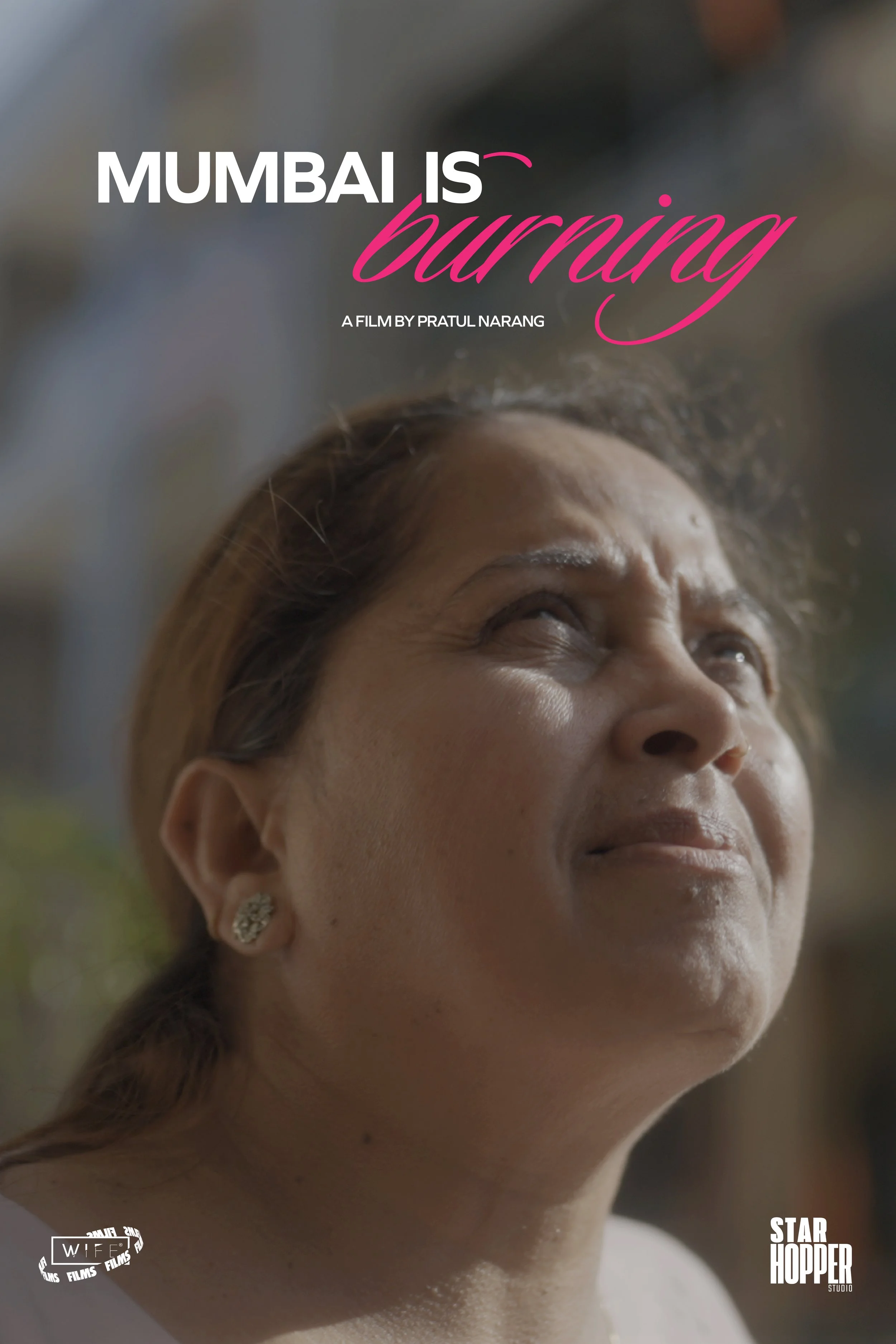 Close-up of a woman's face with a subtle smile, earrings, and light makeup, with text overlay reading 'Mumbai is burning,' 'A film by Pratul Narang,' and 'Star Hopper Studio'.