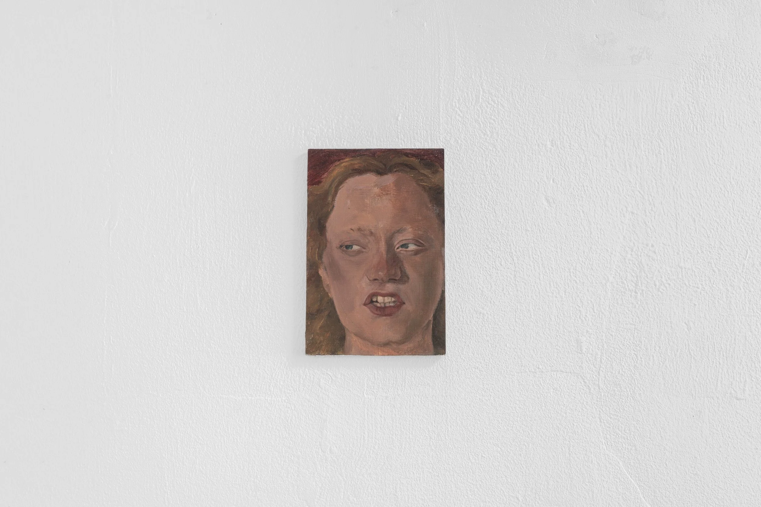 Close-up of a painted portrait of a woman with light skin and brown hair, positioned against a white textured wall.
