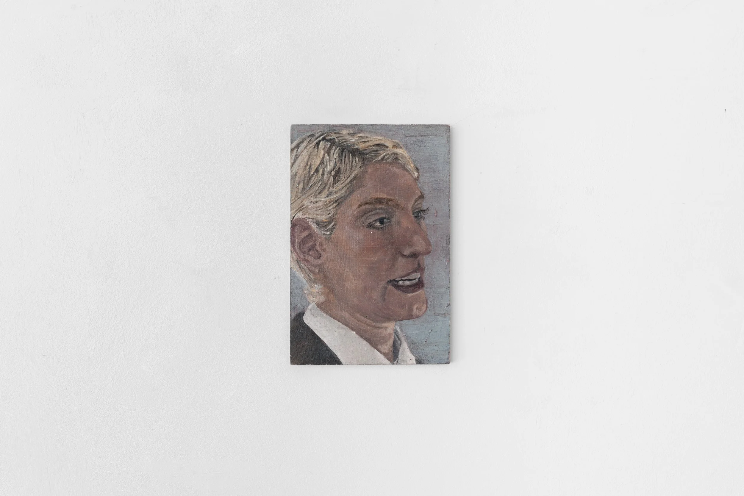 A portrait painting of a woman with blonde hair, wearing a black and white outfit, displayed on a white wall.