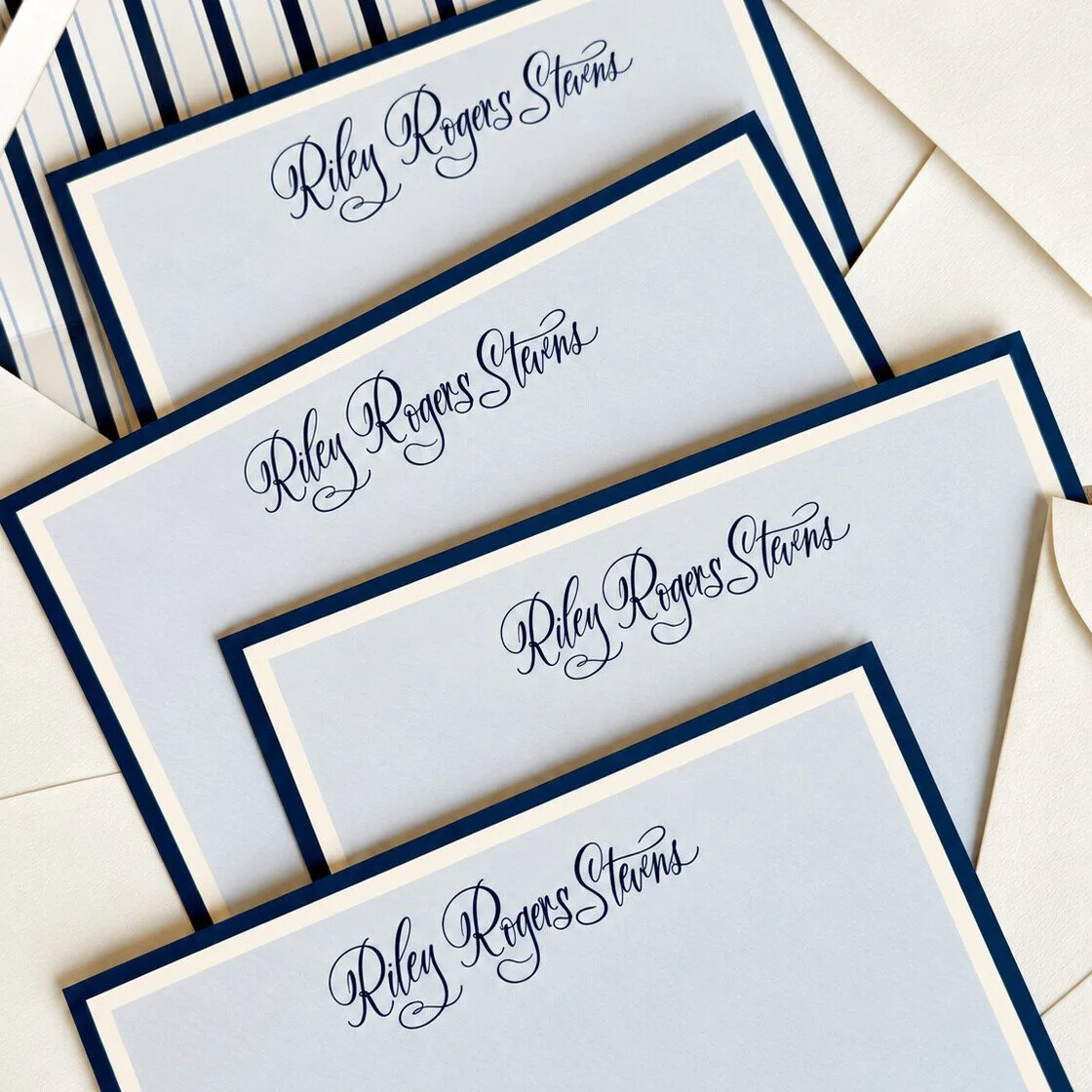 Custom pale blue stationery with navy borders and hand-lettered names by Meg & Co