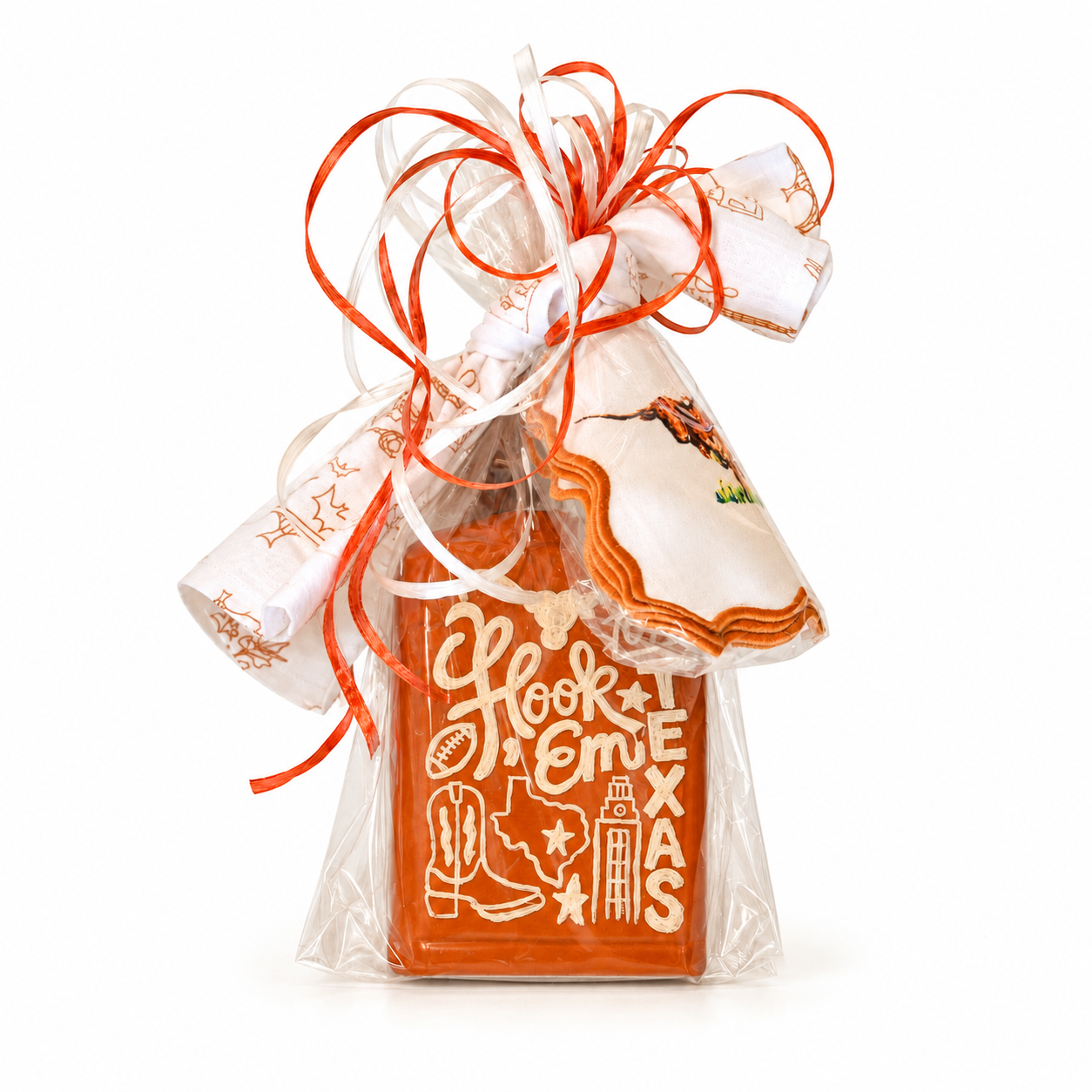 Hand-painted burnt-orange Texas Longhorns bottle with “Hook ’Em” lettering, wrapped in cellophane with orange and ivory ribbons and coordinating linens.