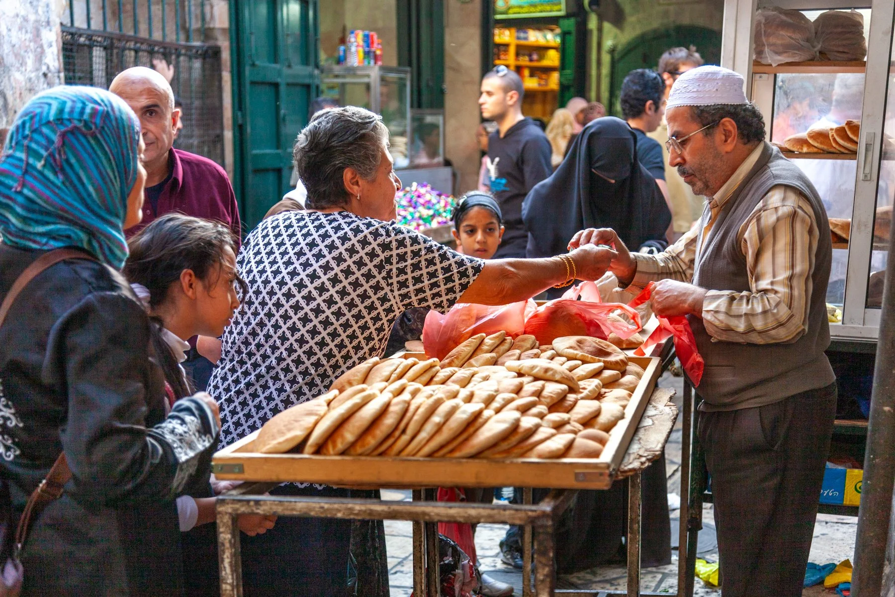 Bread seller serving customers at a bakery in Jerusalem’s Old City.
