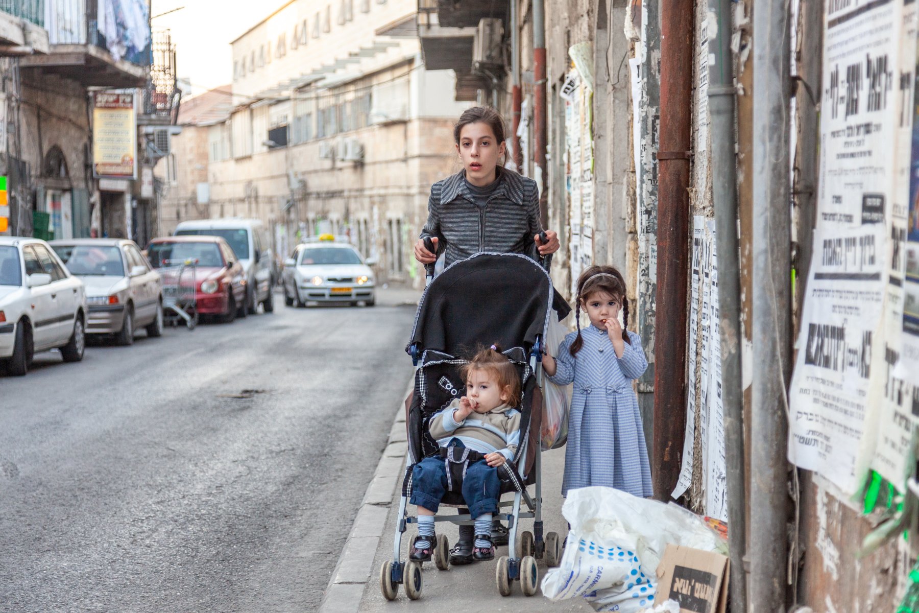 Orthodox Jewish mother pushing a baby stroller in the Mea Shearim neighborhood of Jerusalem.