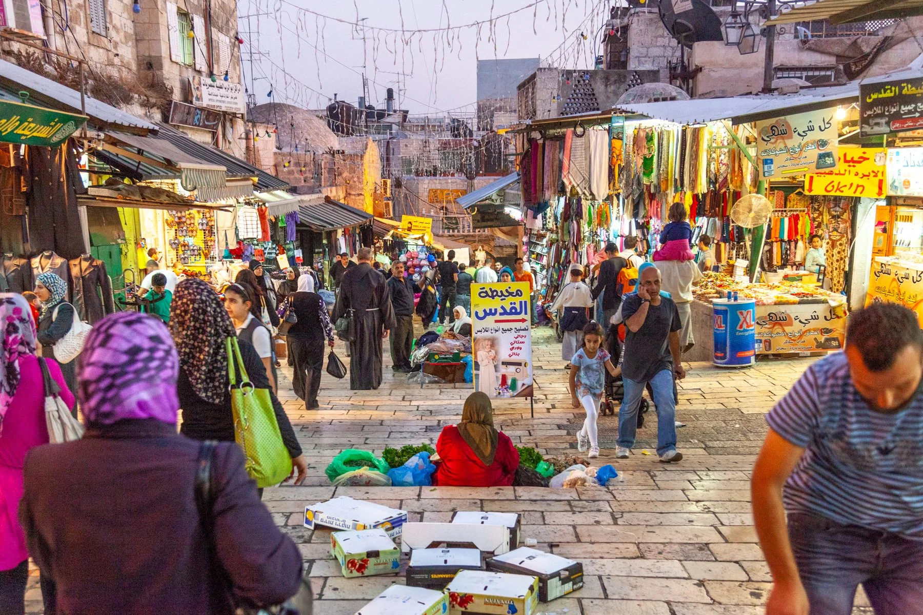 People walking through a busy market street in Jerusalem’s Old City.