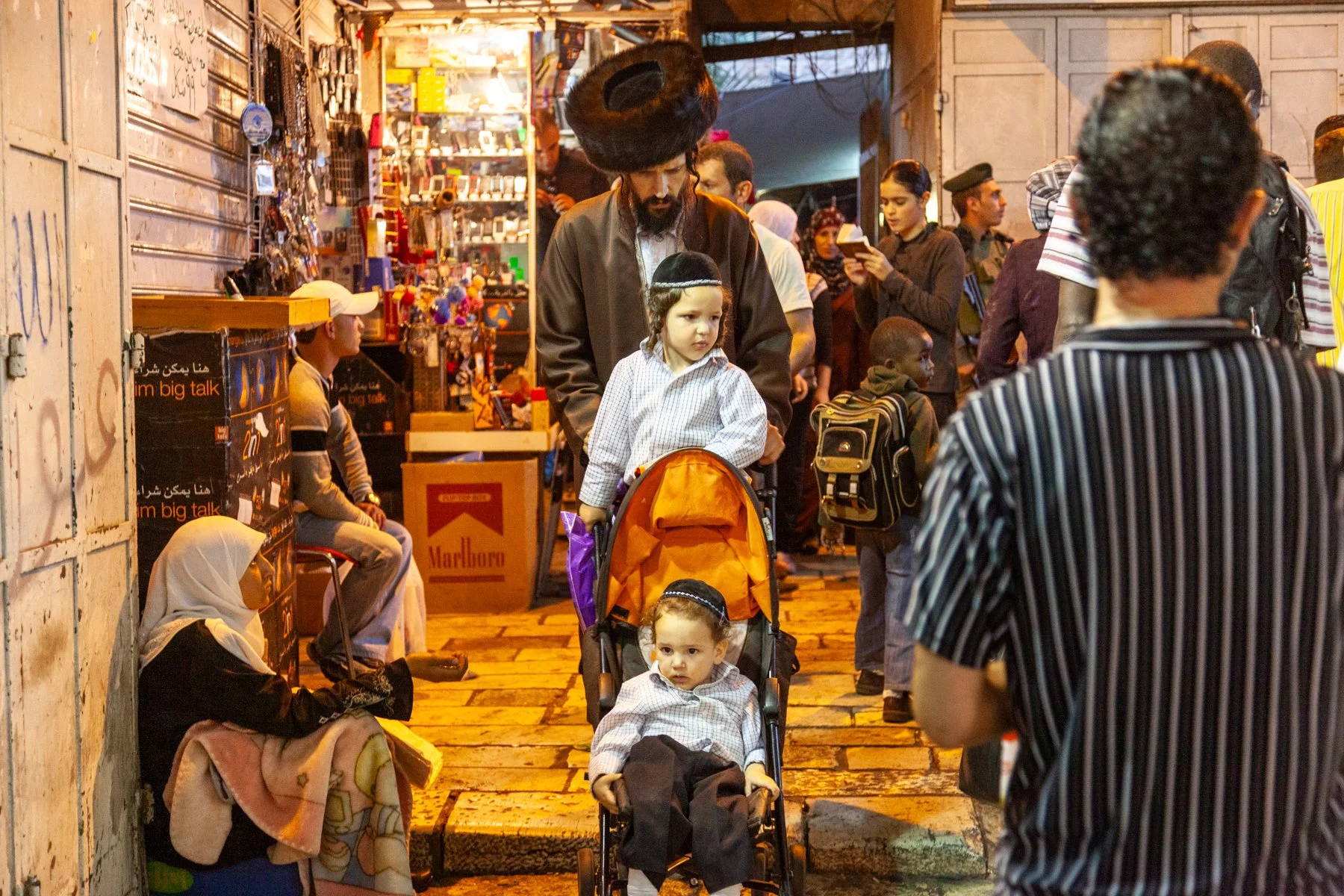 Orthodox Jewish father pushing a baby stroller in Jerusalem’s Old City.