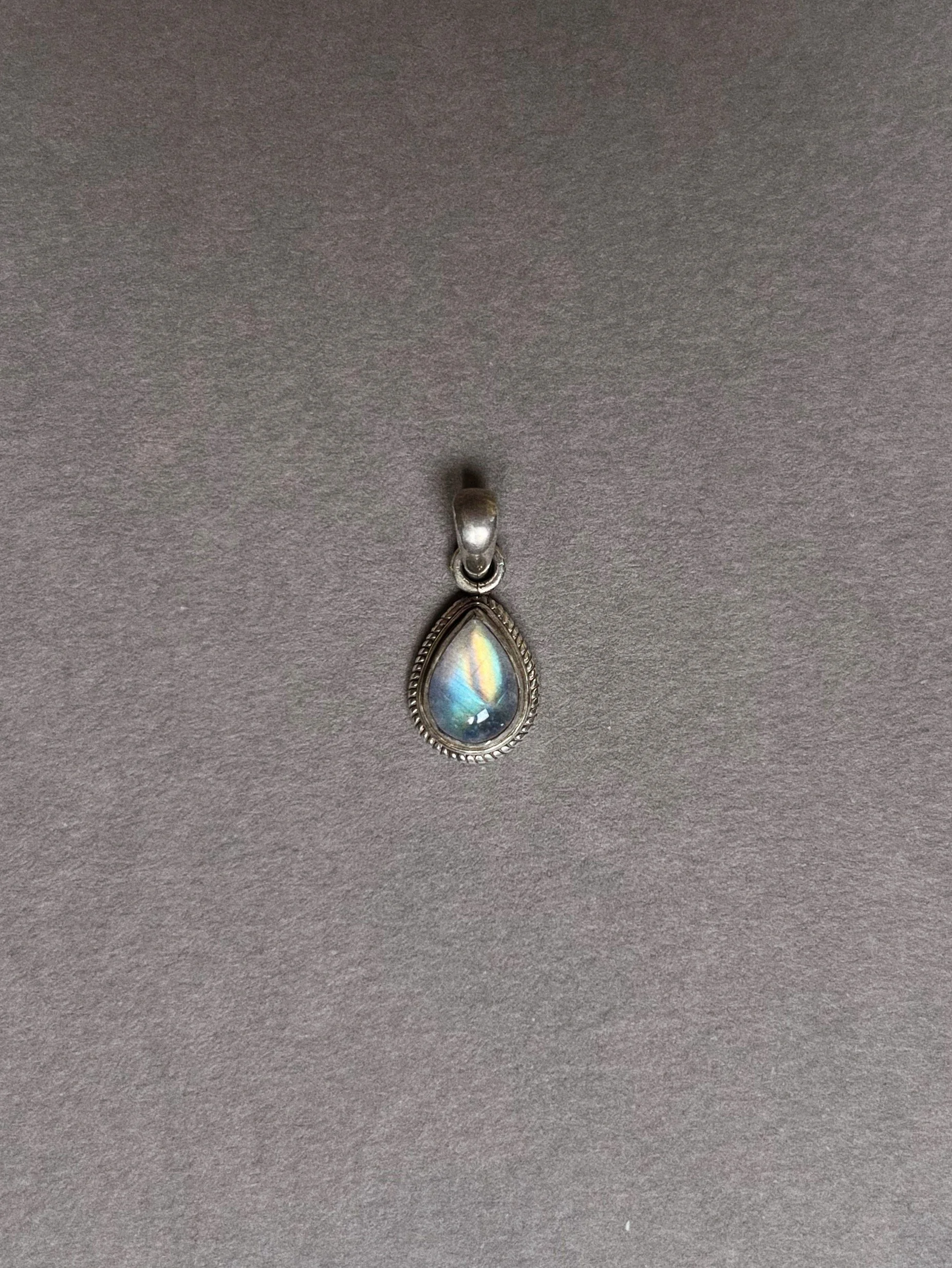 A rainbow trapped inside a pendant