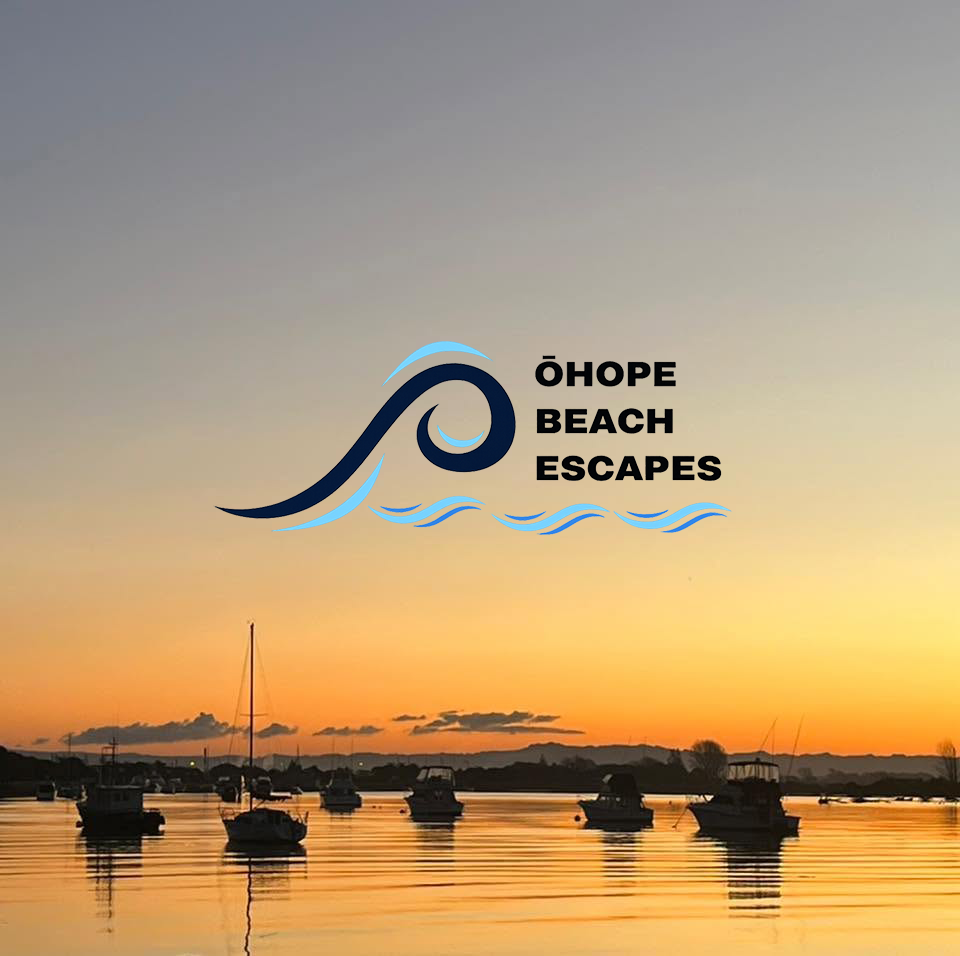Sunset over calm waters with boats anchored, and a logo for Ôhope Beach Escapes featuring a stylized wave and beach name.