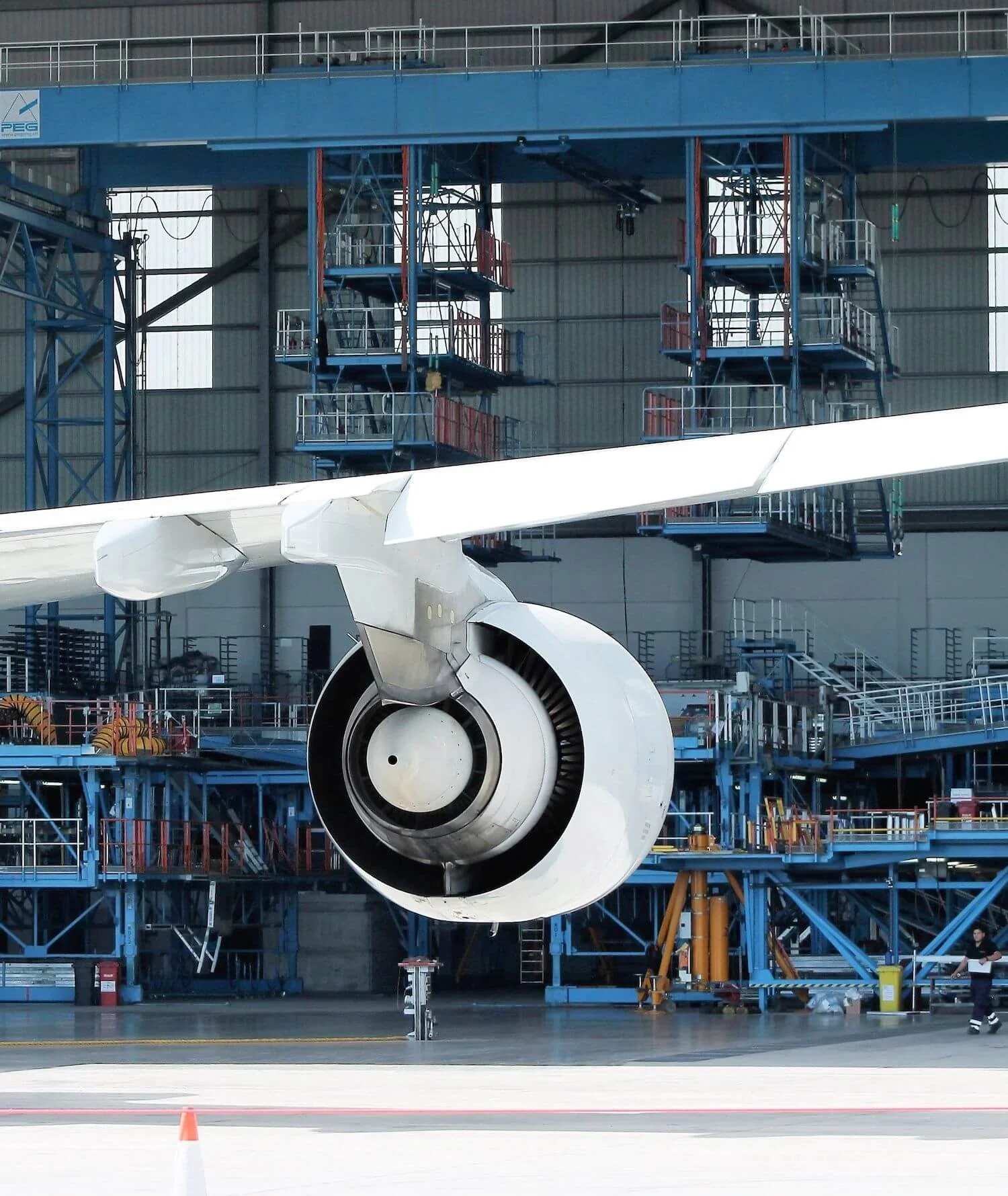 Close-up view of an aircraft's engine in a well-lit maintenance hangar