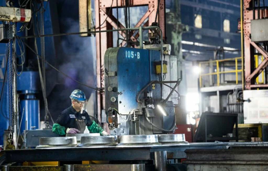 a worker working at a machine inside the Weber Metals factor