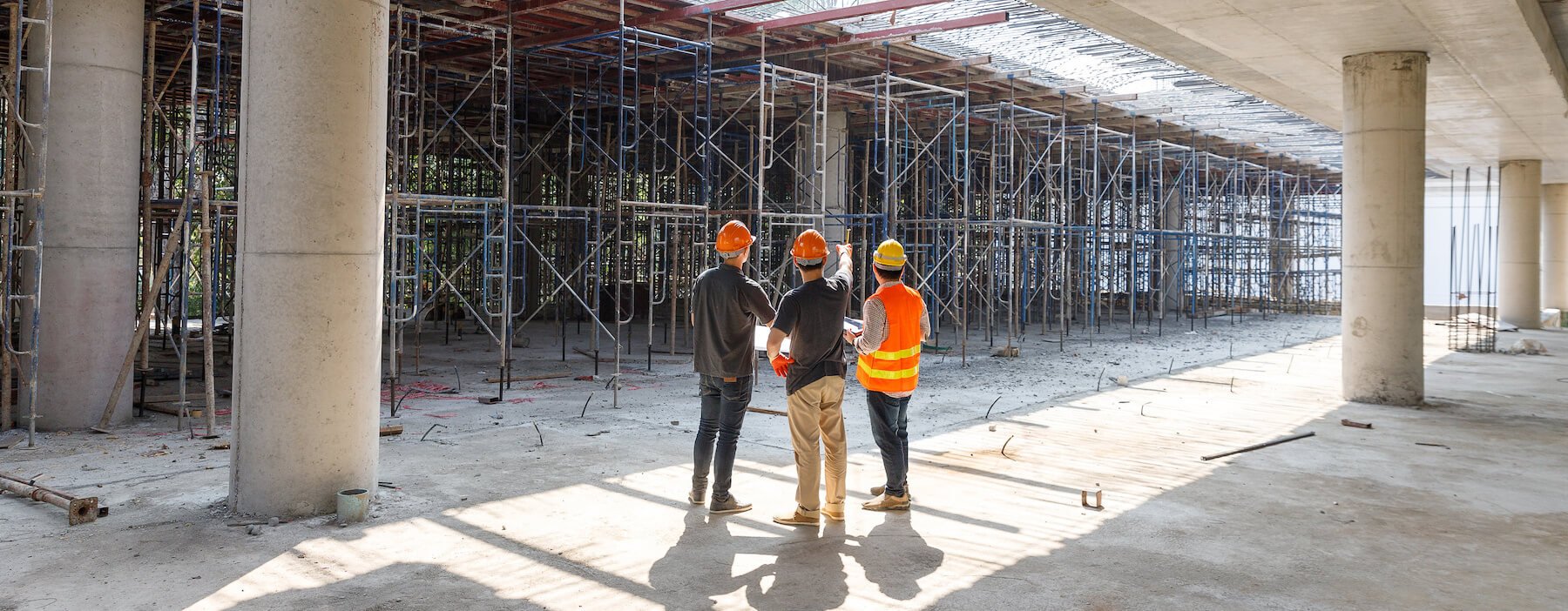 architects and engineer standing at a construction site together