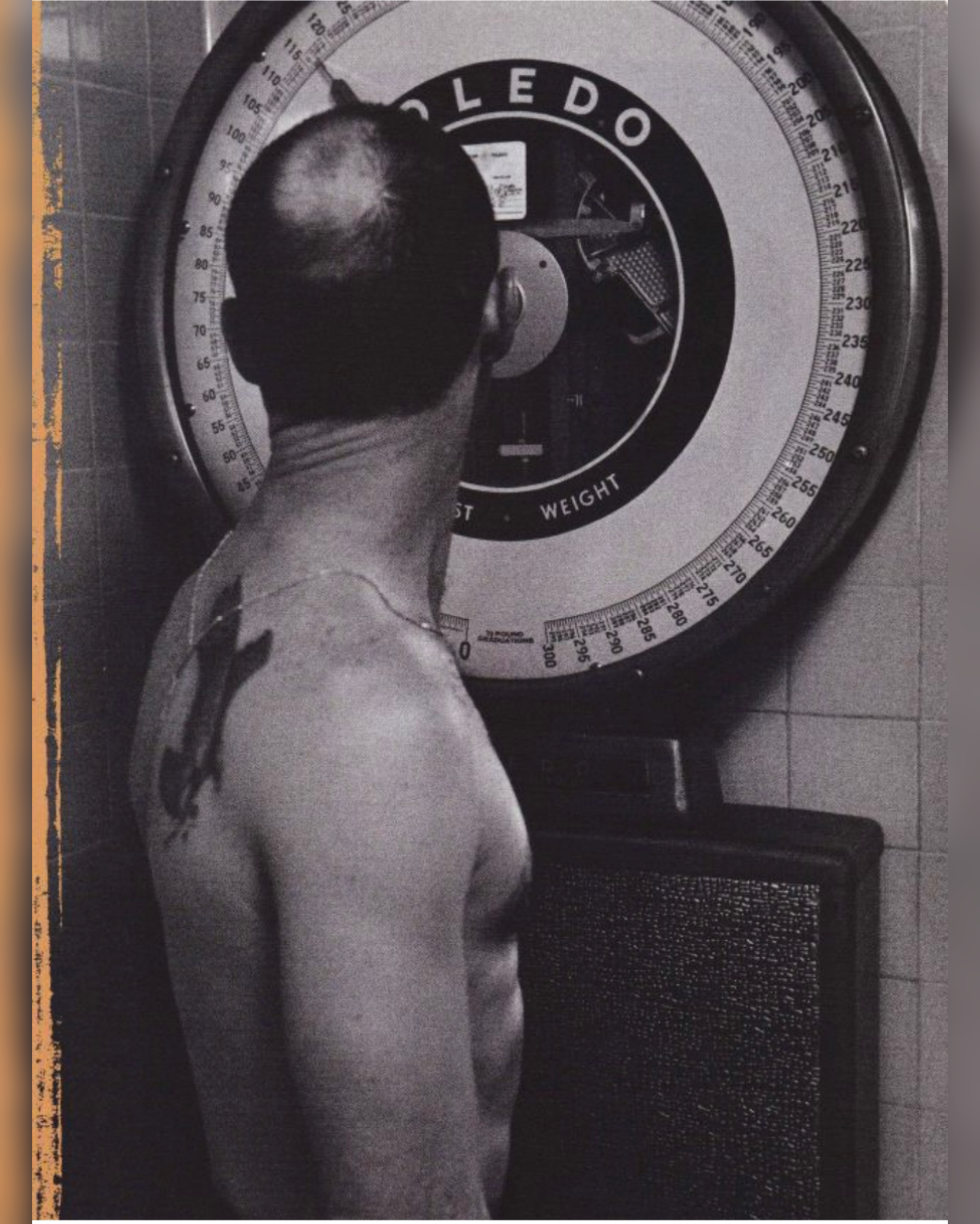 A person standing on a scale in a bathroom, viewed from above, with their head and shoulders visible.