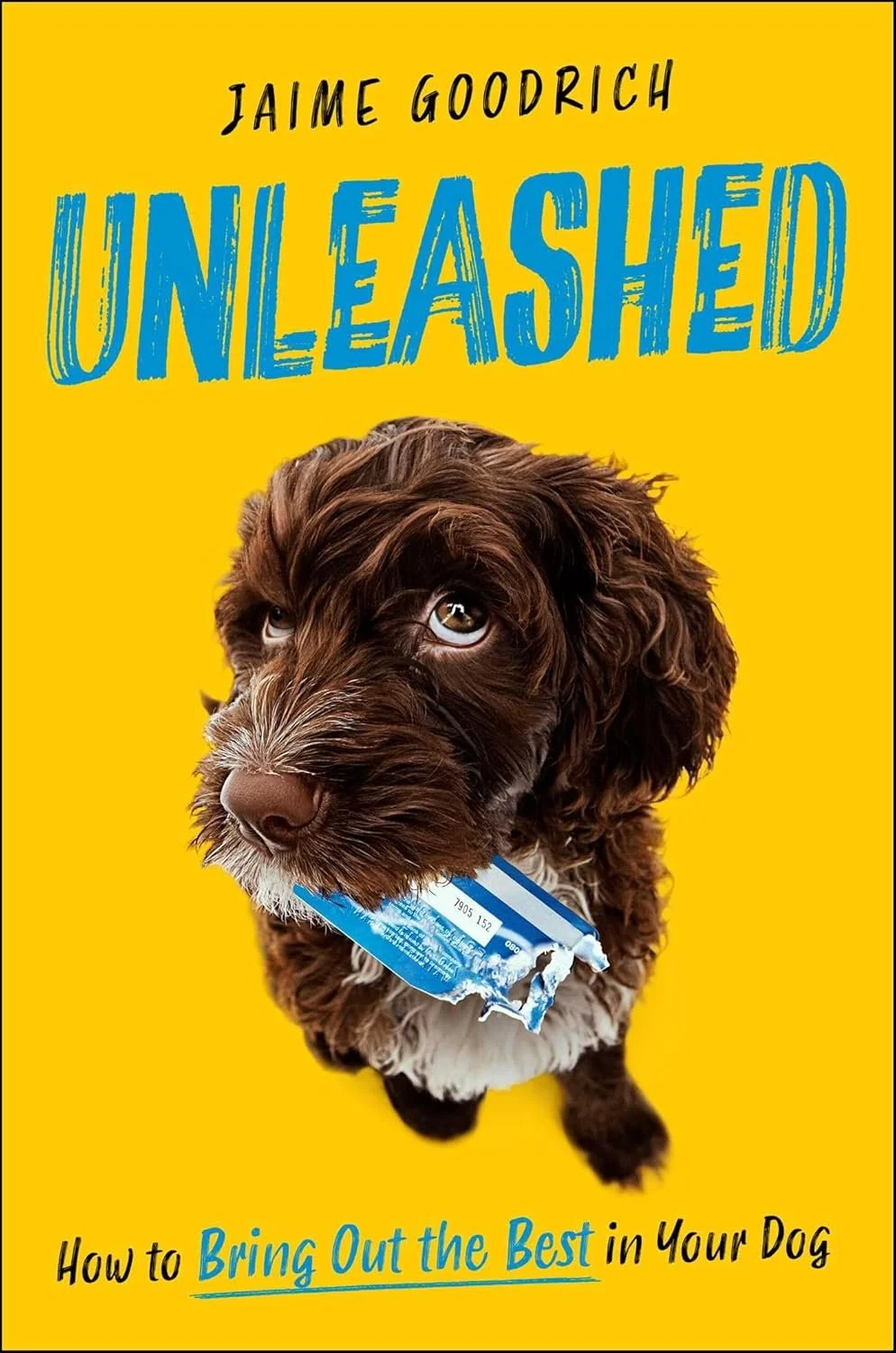 A book cover titled 'Unleashed' by Jaime Goodrich, featuring a puppy with a chewed credit card in its mouth against a yellow background. The subtitle reads 'How to Bring Out the Best in Your Dog.'
