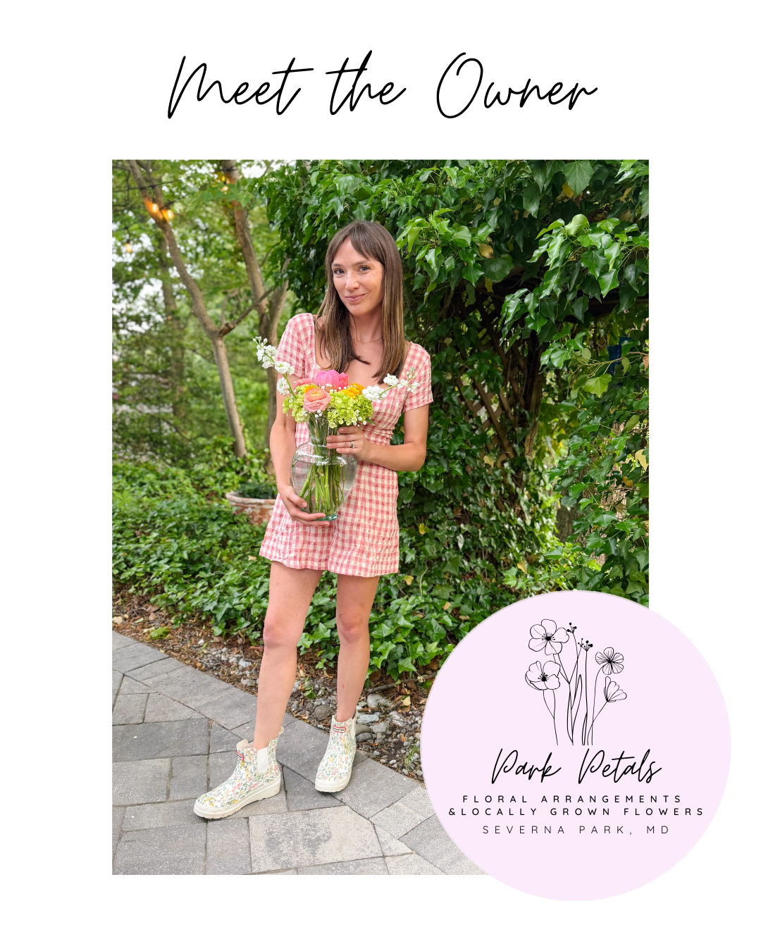 A woman in a pink checkered dress and floral boots holding a glass vase with pink and white flowers, standing outdoors near green foliage and a stone walkway.