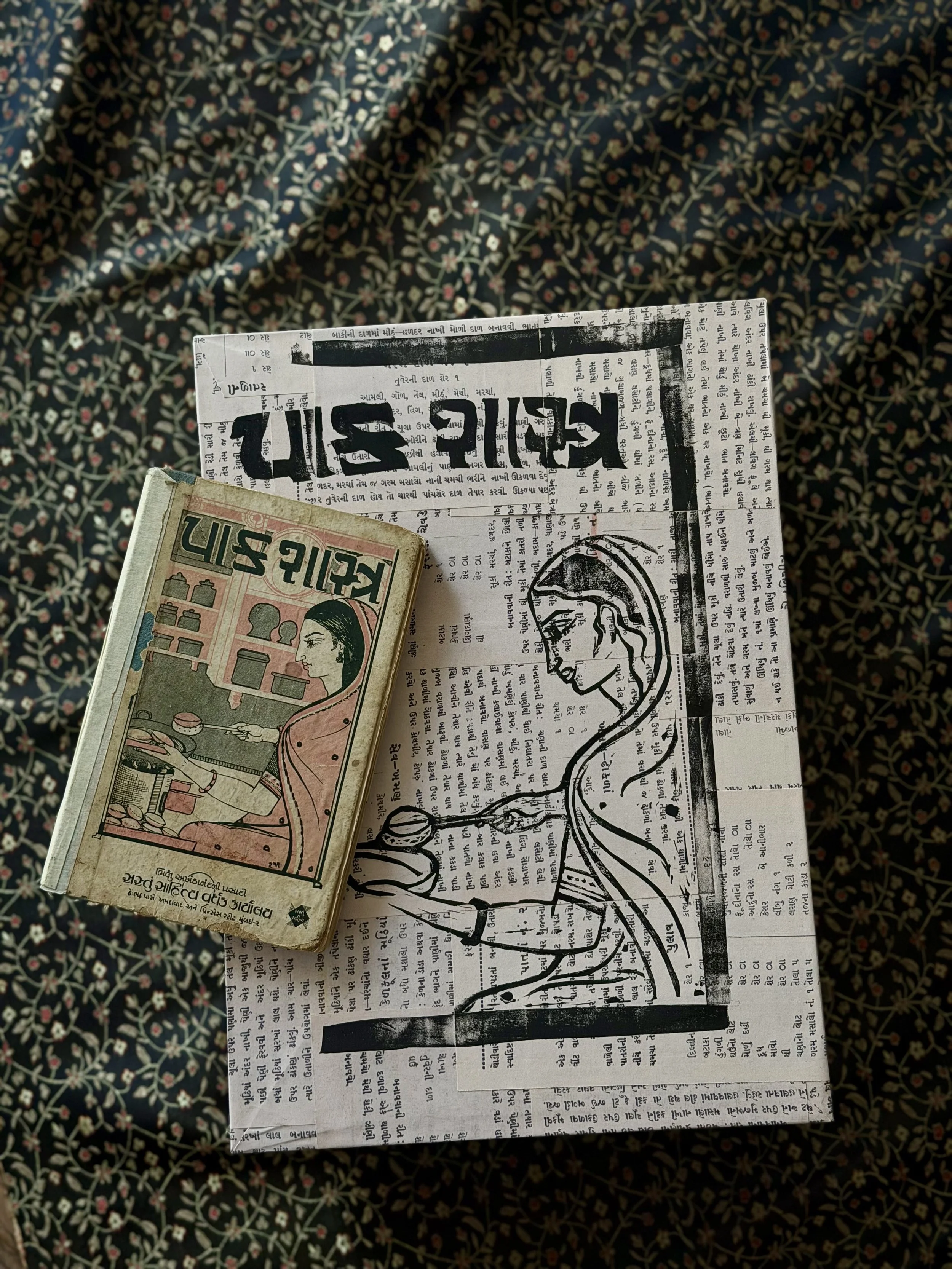 (re)Crafting the Self, here with the source material and inspiration, a Gujarati cookbook written by my great-great-grandmother titled Paak Shastra. Both are pictured against the same fabric that lines the inside of (re)Crafting the Self.