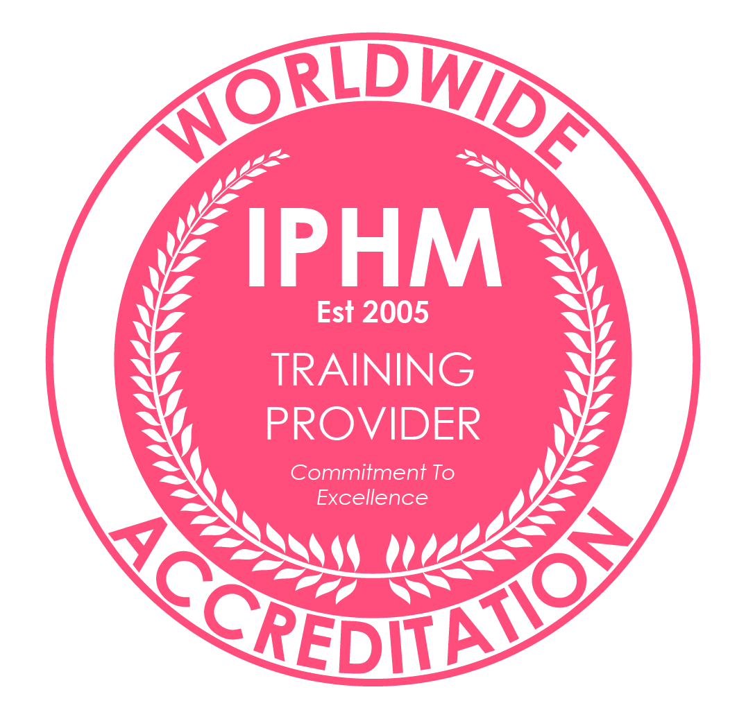 Pink circular badge with white and pink text that reads "World Wide Accreditation" at the top, "IPHM" in the center, "Est 2005," "Training Provider," and "Commitment To Excellence".