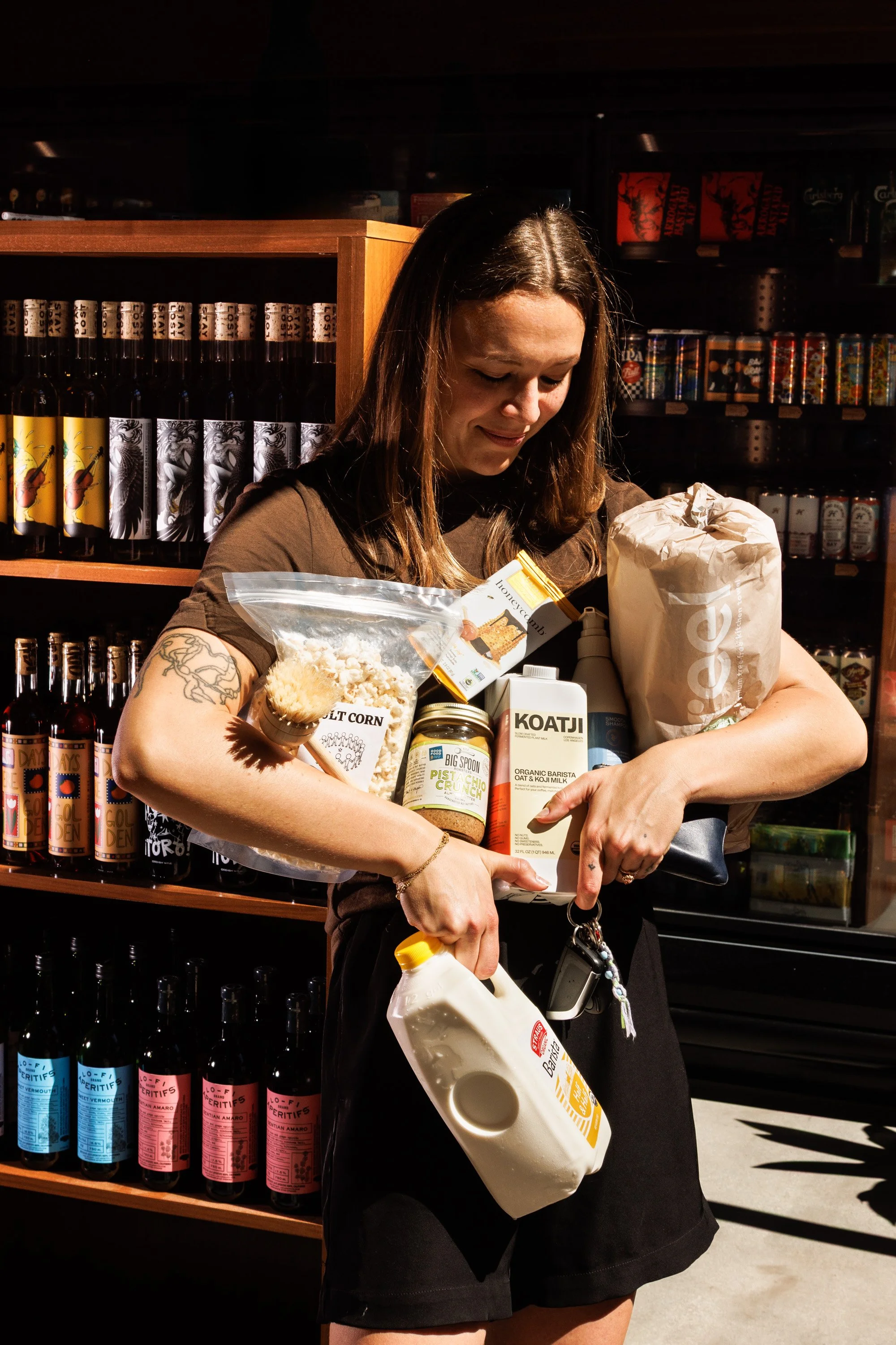 Commercial lifestyle photo of a woman holding groceries in a local bodega in Southern California for a brand campaign.