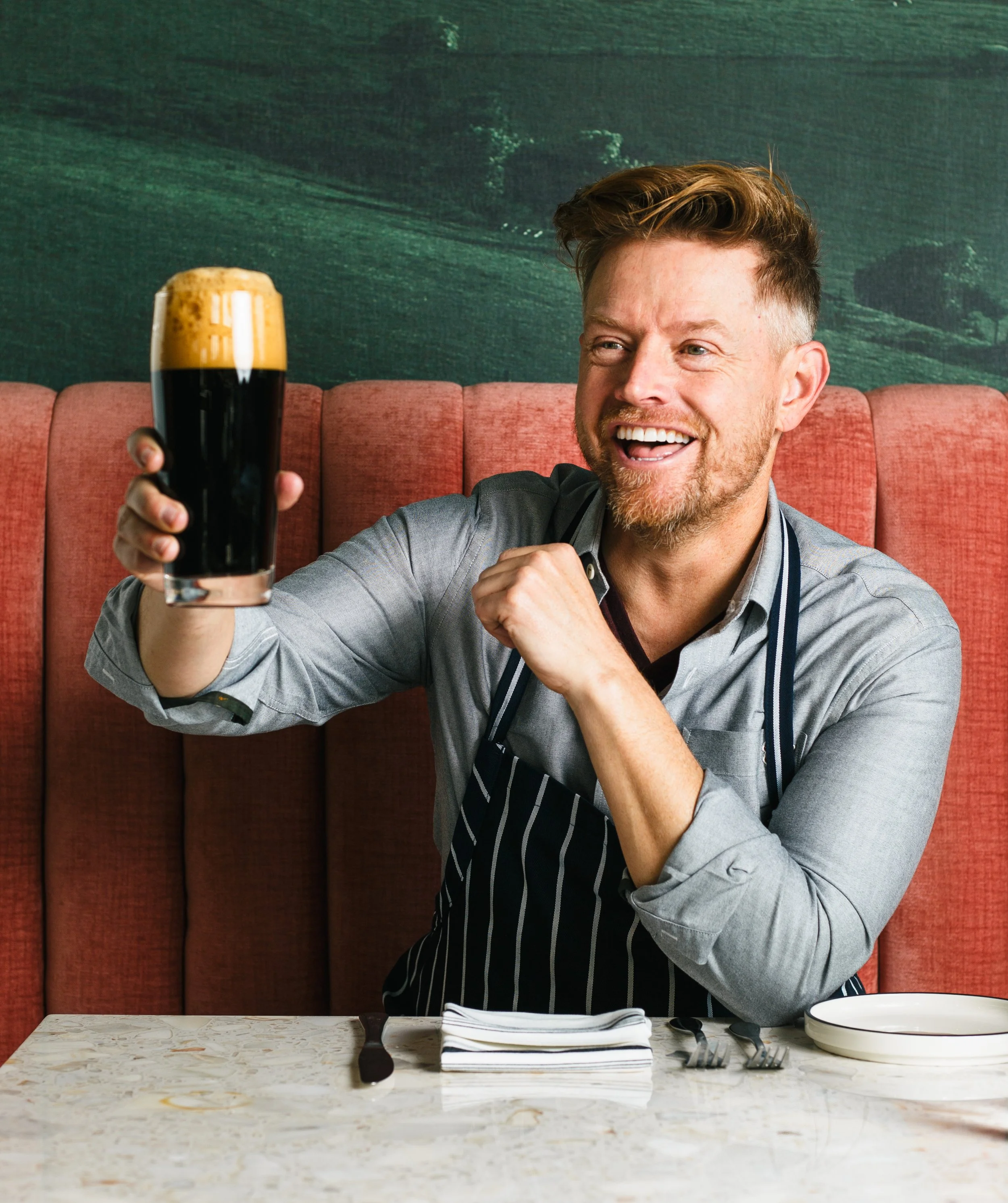 Commercial food, lifestyle and hospitality photo of celebrity chef Richard Blais raising a glass of Guinness in his restaurant in San Diego, California.