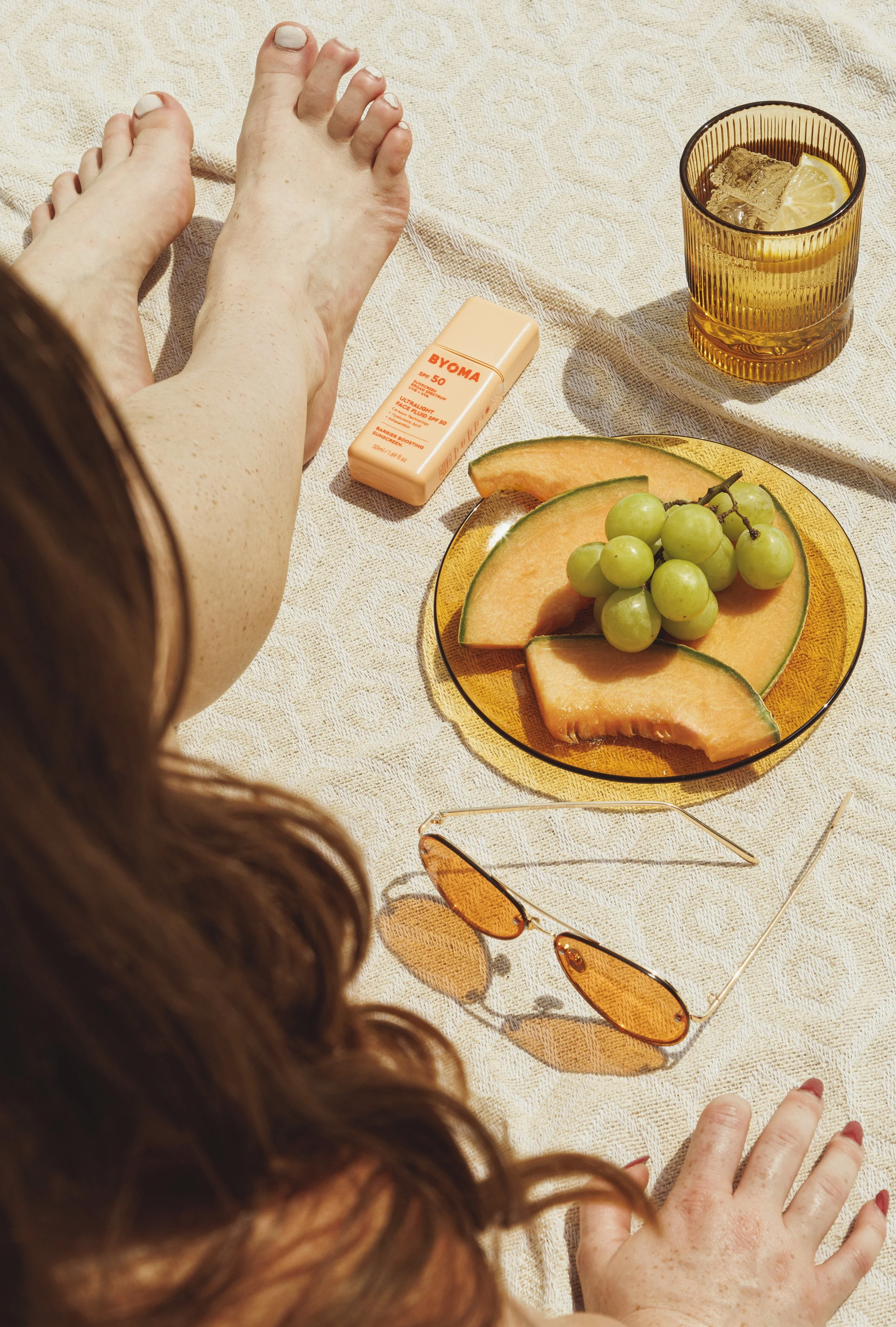 Commercial lifestyle product photo of a woman with freckles for a sunscreen advertisement.