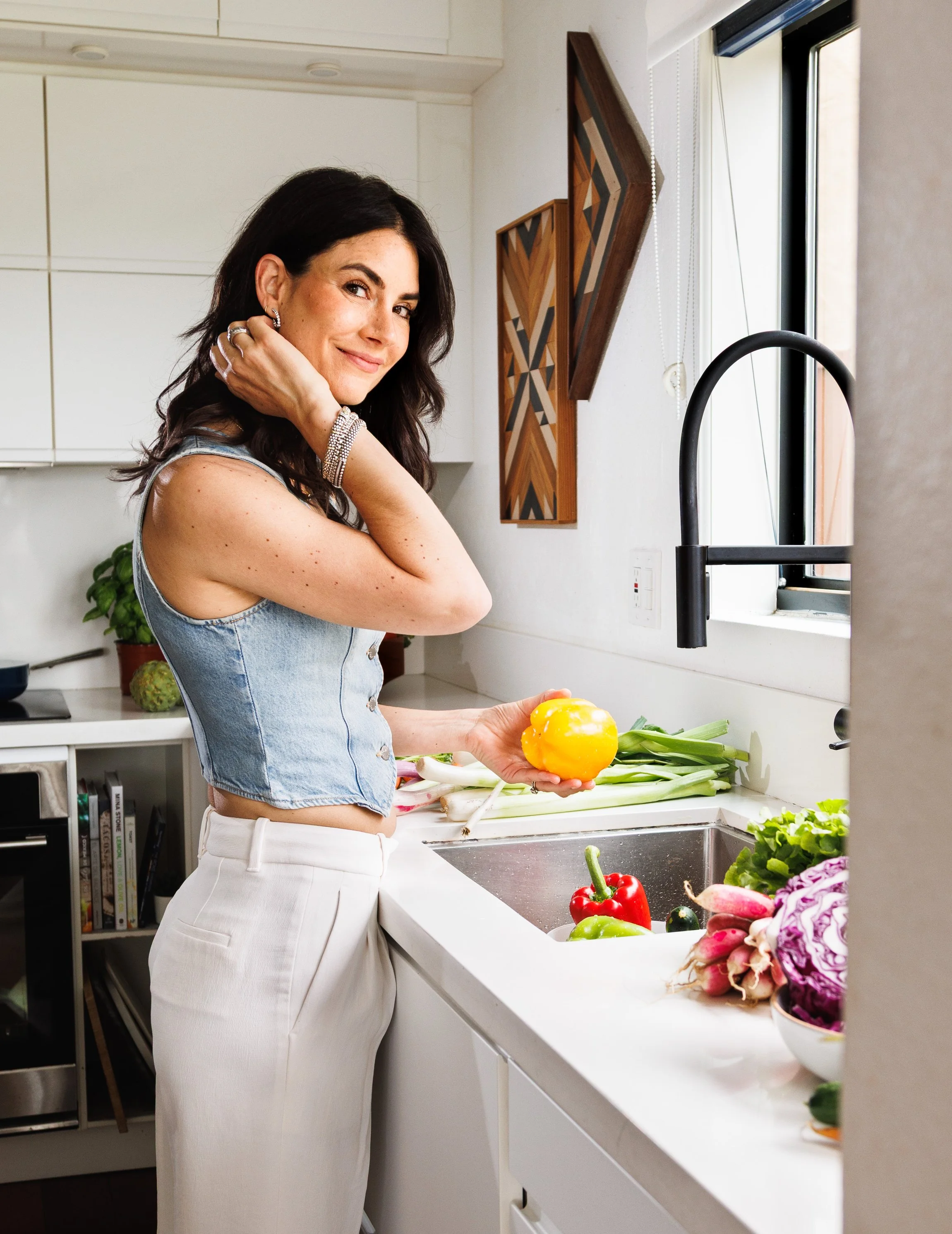 Commercial lifestyle photo of a woman washing vegetables for a wellness brand in San Diego, California.