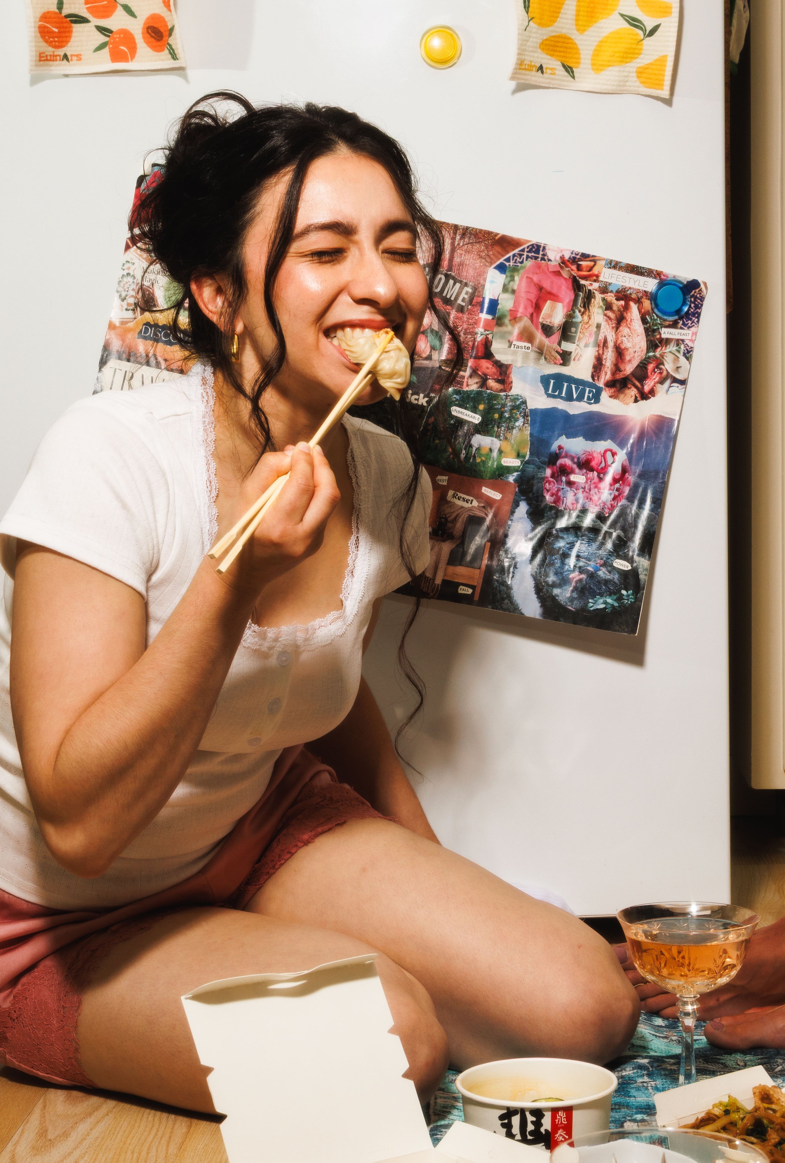 Commercial food lifestyle photo of a woman eating a dumpling for an advertising campaign.
