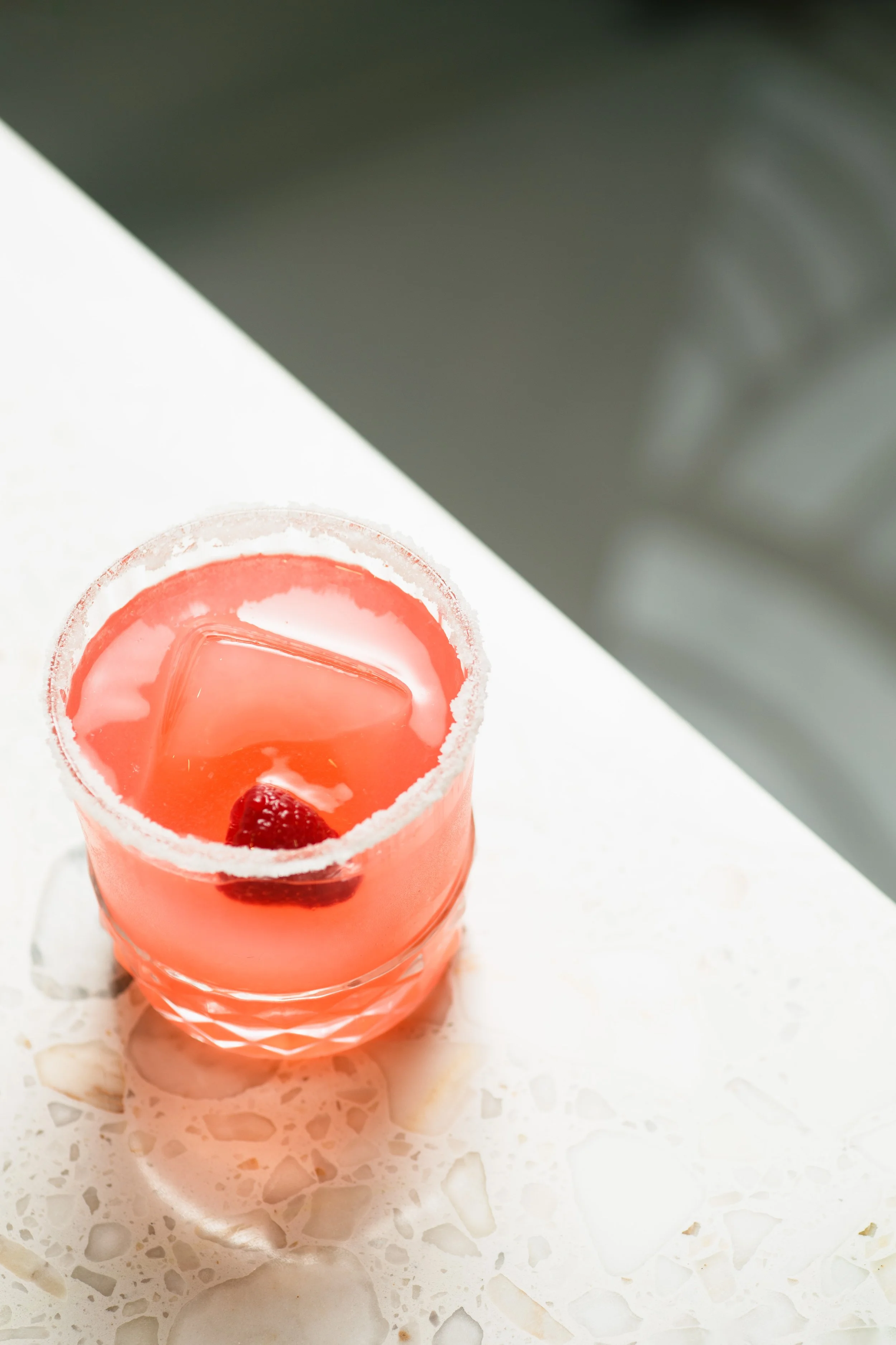 Commercial beverage photo of a pink cocktail for a restaurant ad.