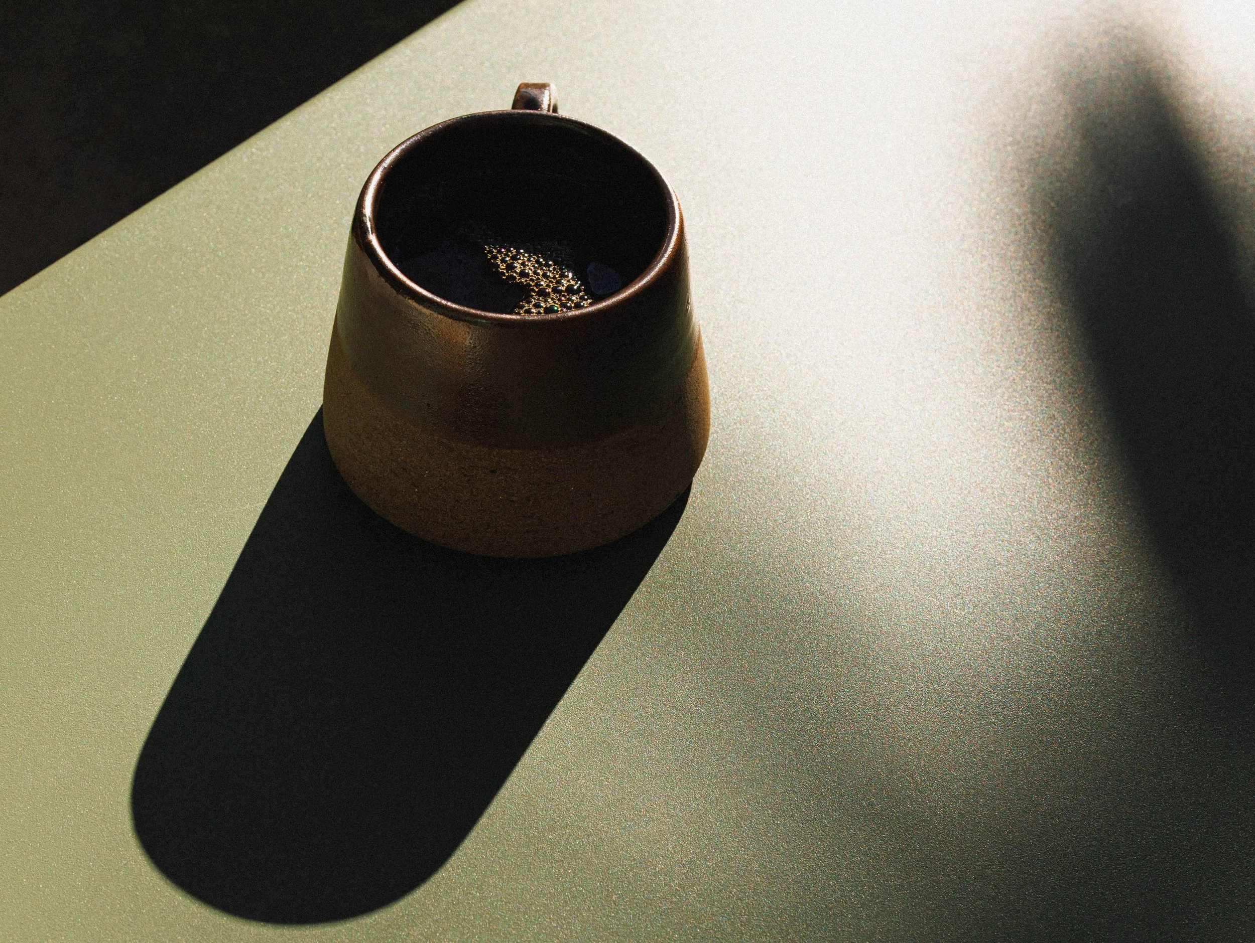 Graphic commercial lifestyle beverage photo of coffee in the sun for a hospitality brand campaign.