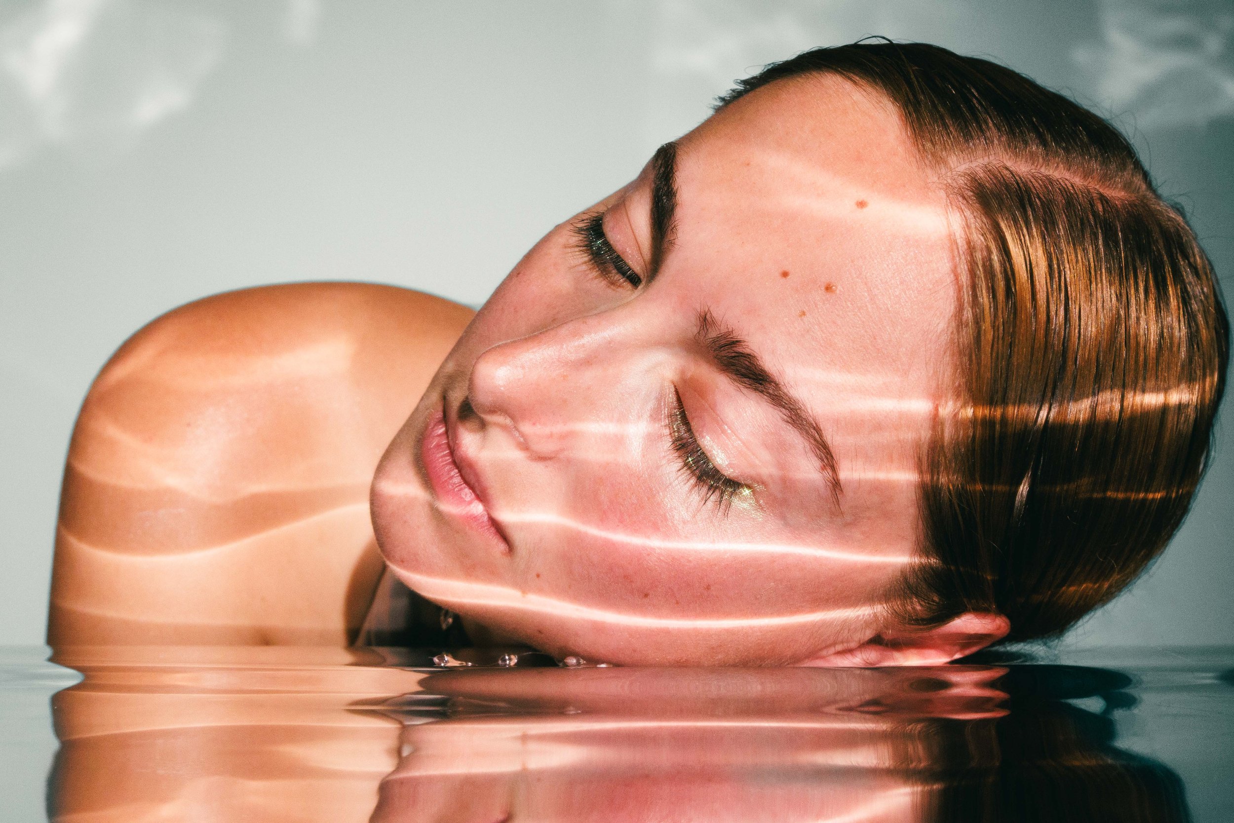 Commercial beauty skincare photo of a woman with glowing natural skin for an advertising campaign.