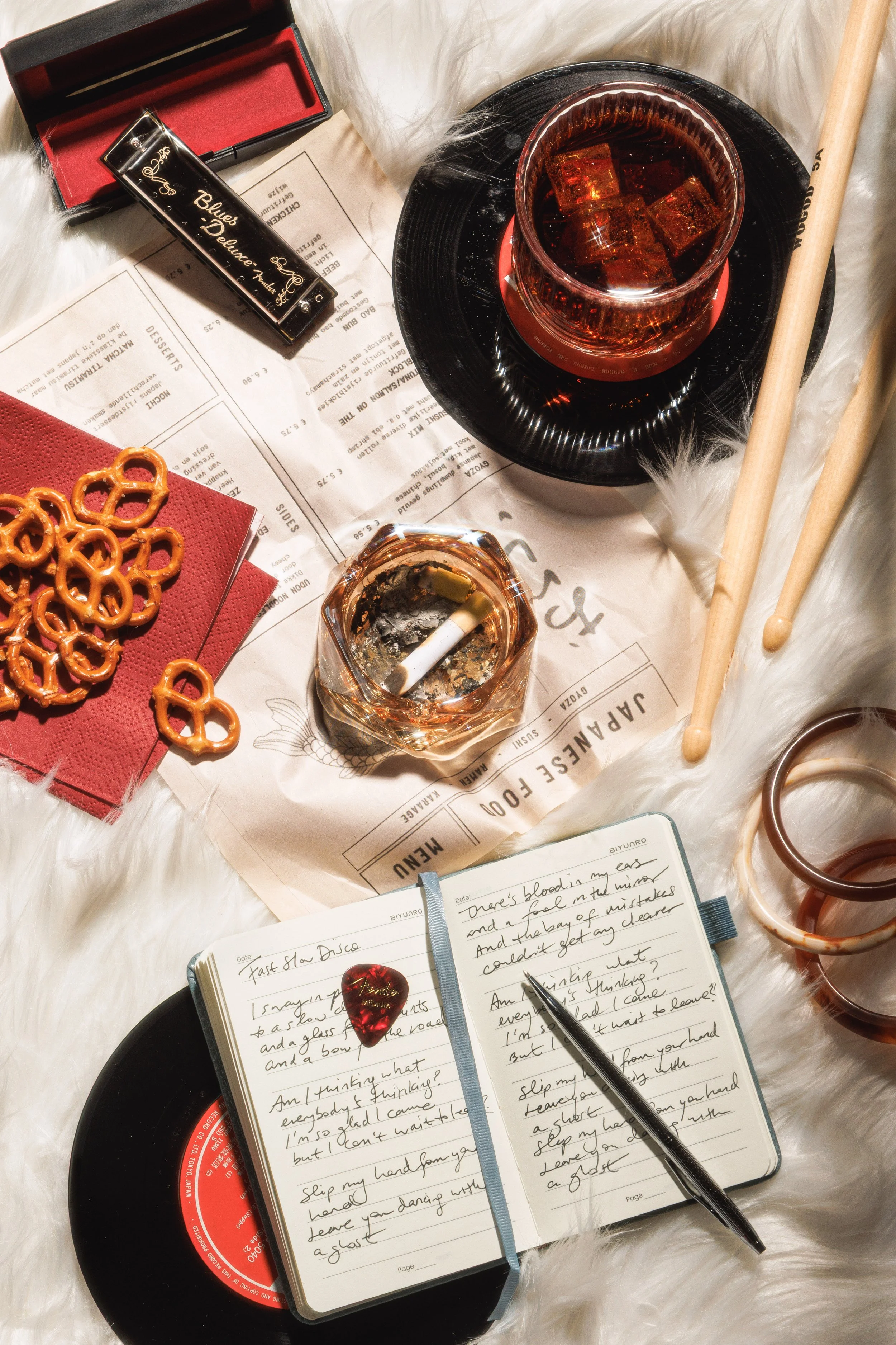 Conceptual still life photo of food, instruments, and drinks for an editorial shoot.