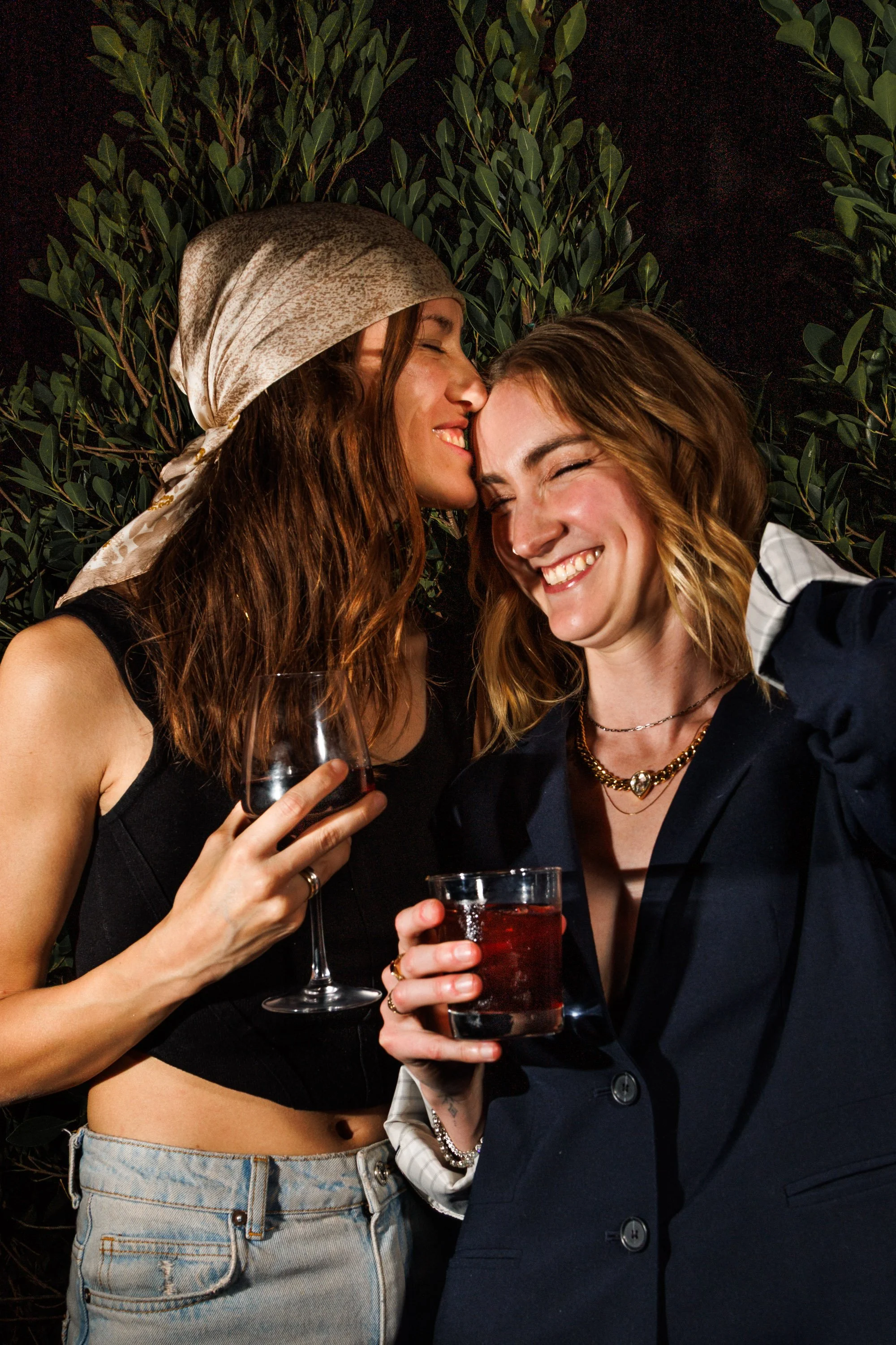 Commercial lifestyle photo of a couple hugging and drinking wine for a hospitality brand campaign by Amy Carson.