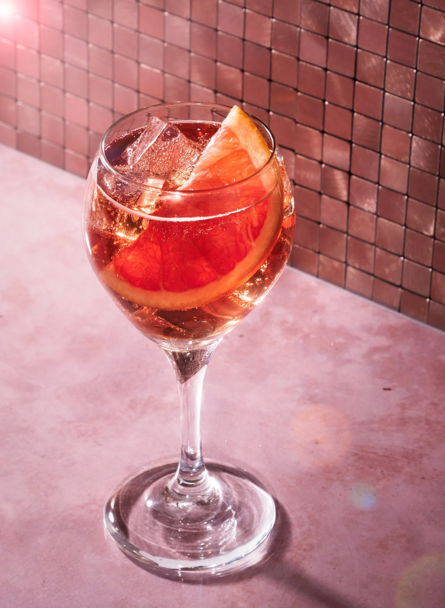 Commercial beverage photo of a glass of Lillet wine with grapefruit for an advertising campaign.