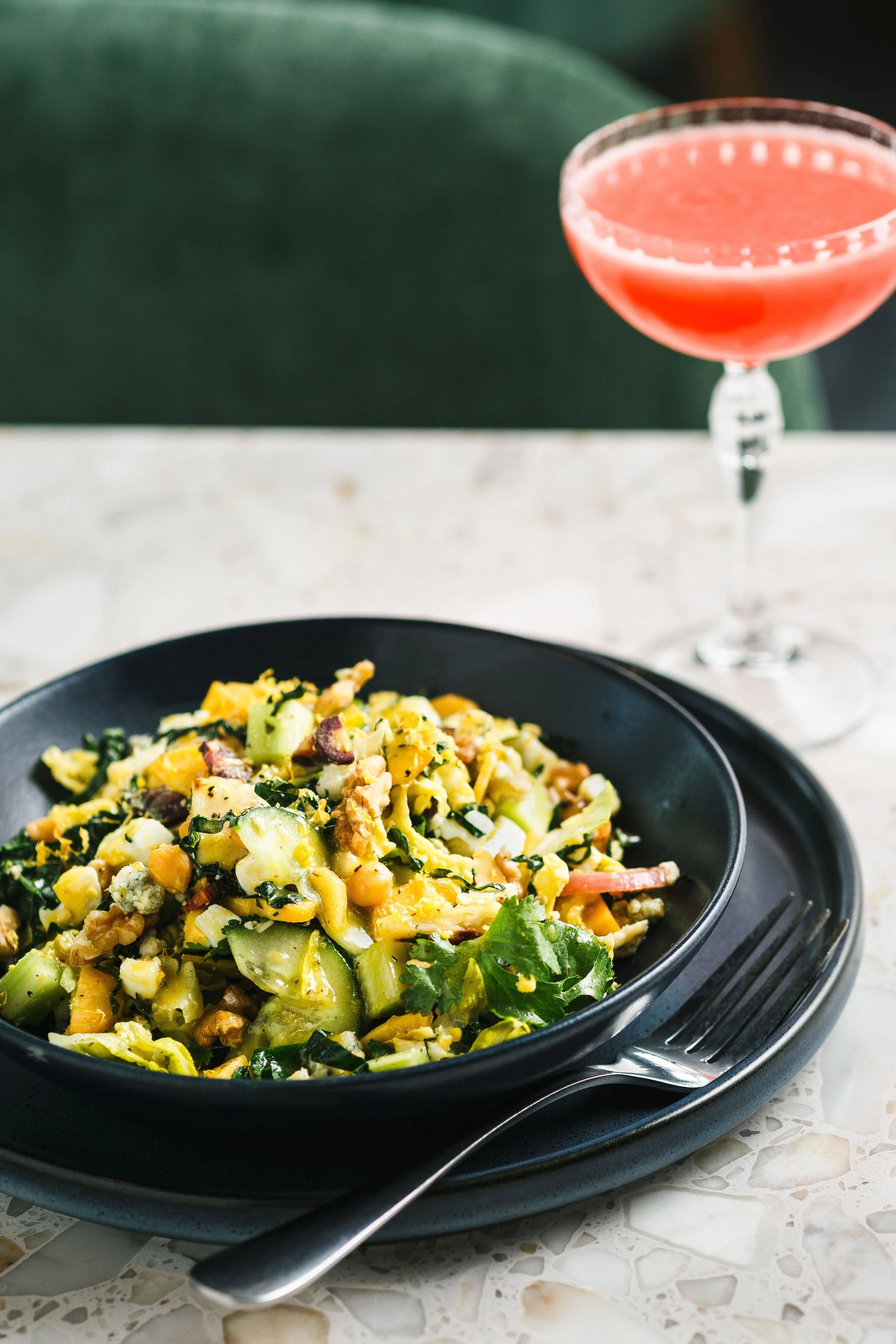 Commercial food photo of a salad and drink for an advertising campaign.