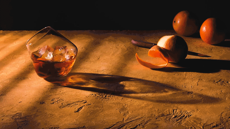 Commercial beverage cinemagraph of a spinning whiskey old fashioned.