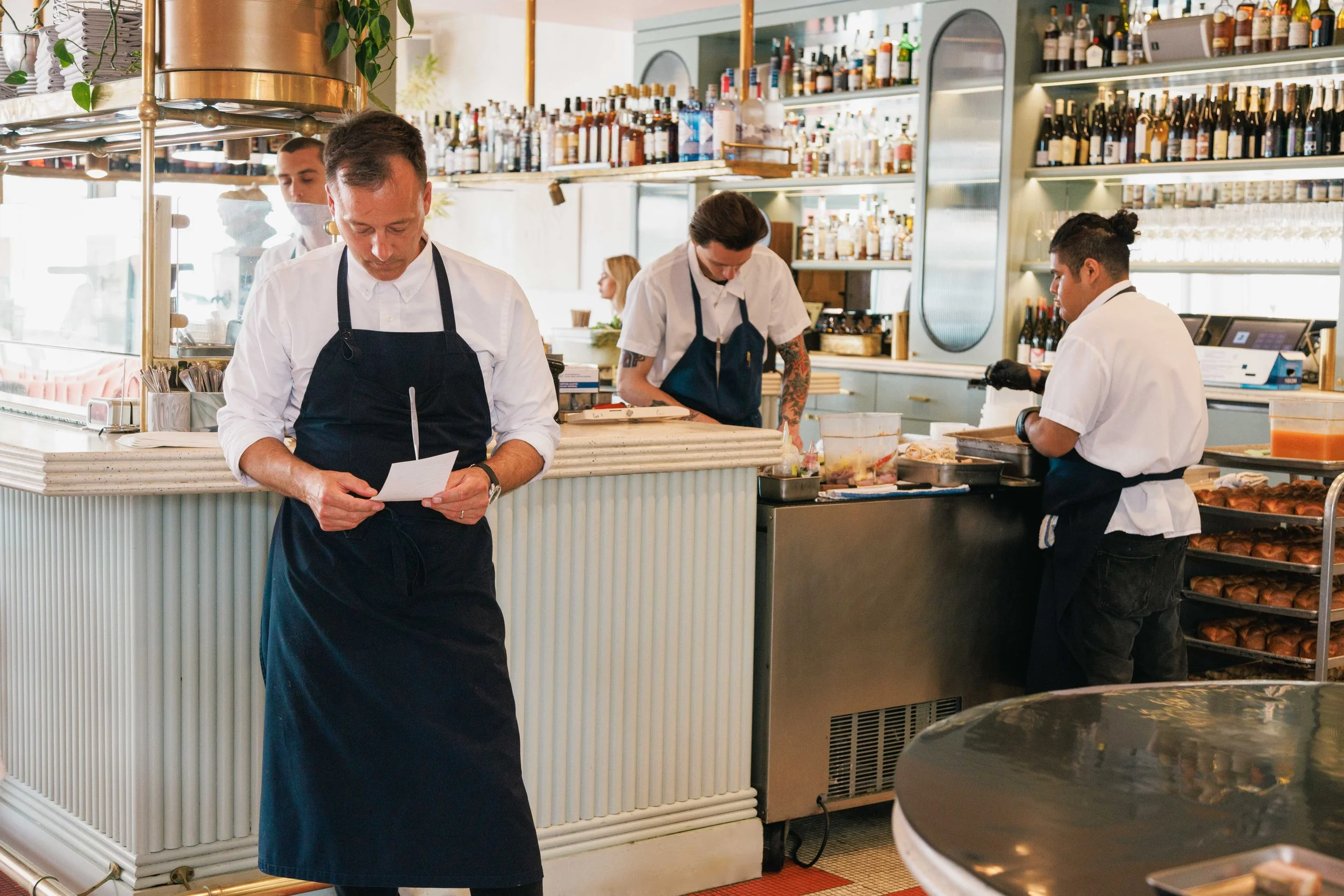 Editorial hospitality photo of chefs working in a restaurant.