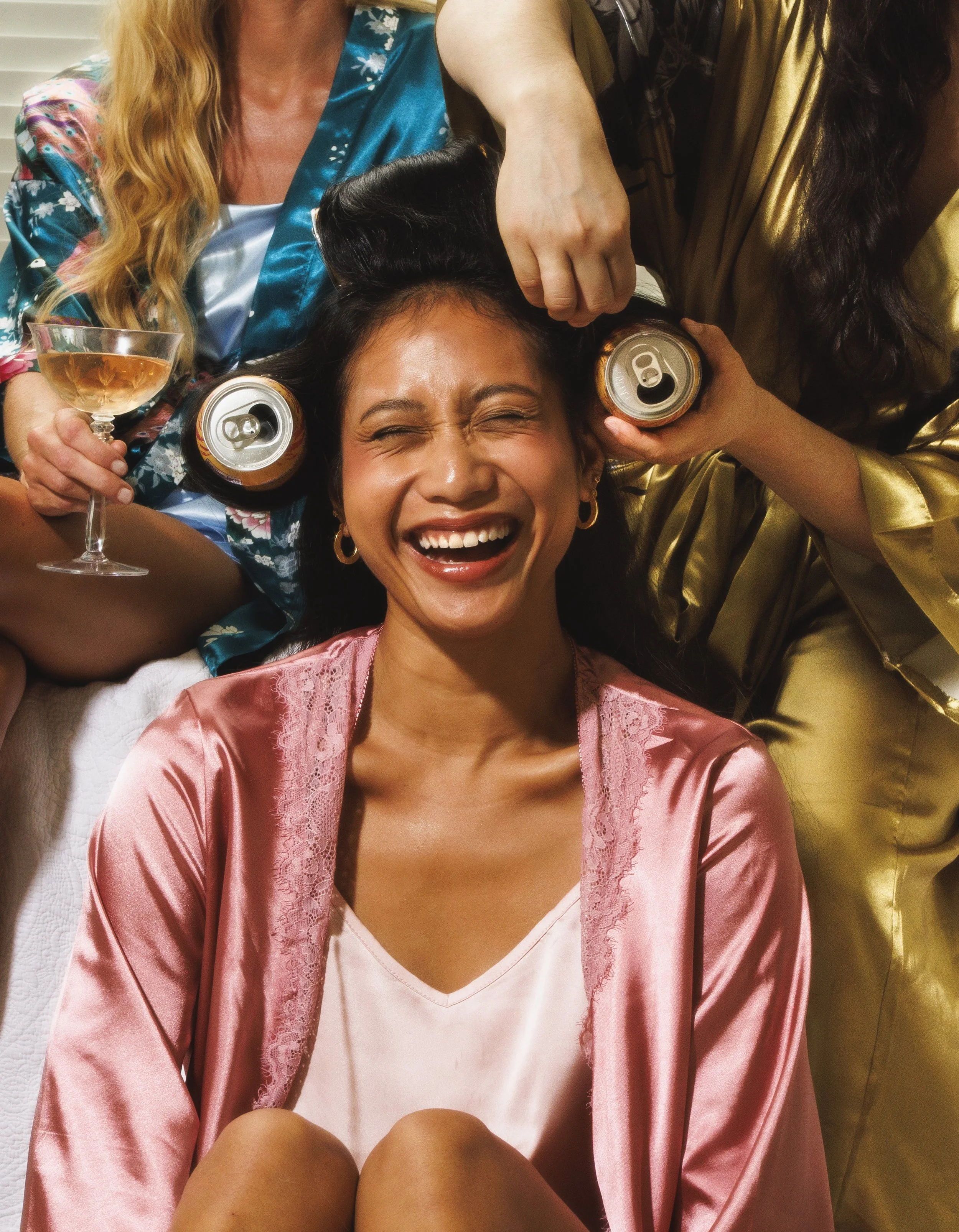 Commercial lifestyle portrait of a woman getting can curlers in her hair for an advertising campaign.