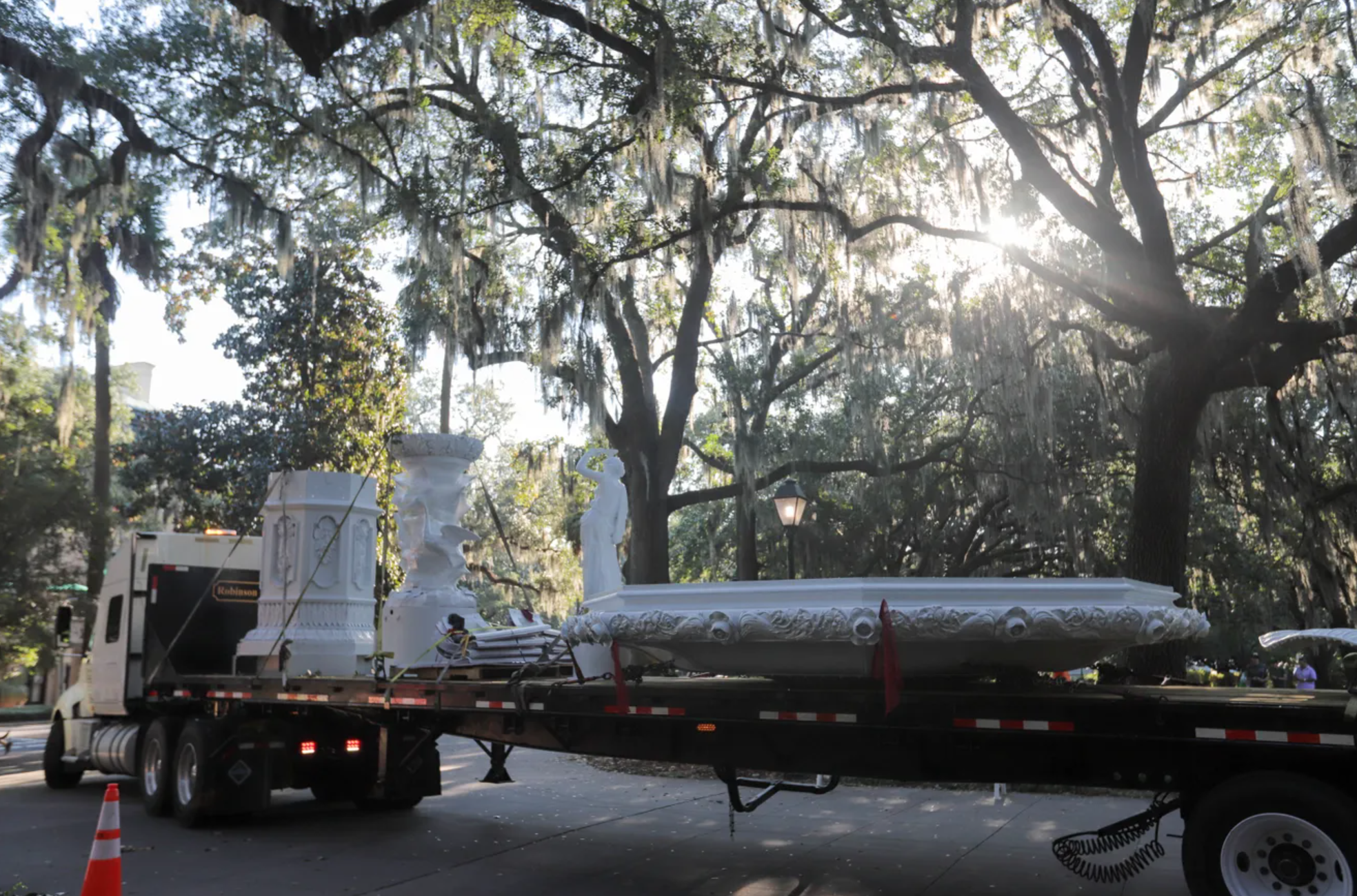 Flatbed truck transporting Forsyth Park Fountain while being restored.
