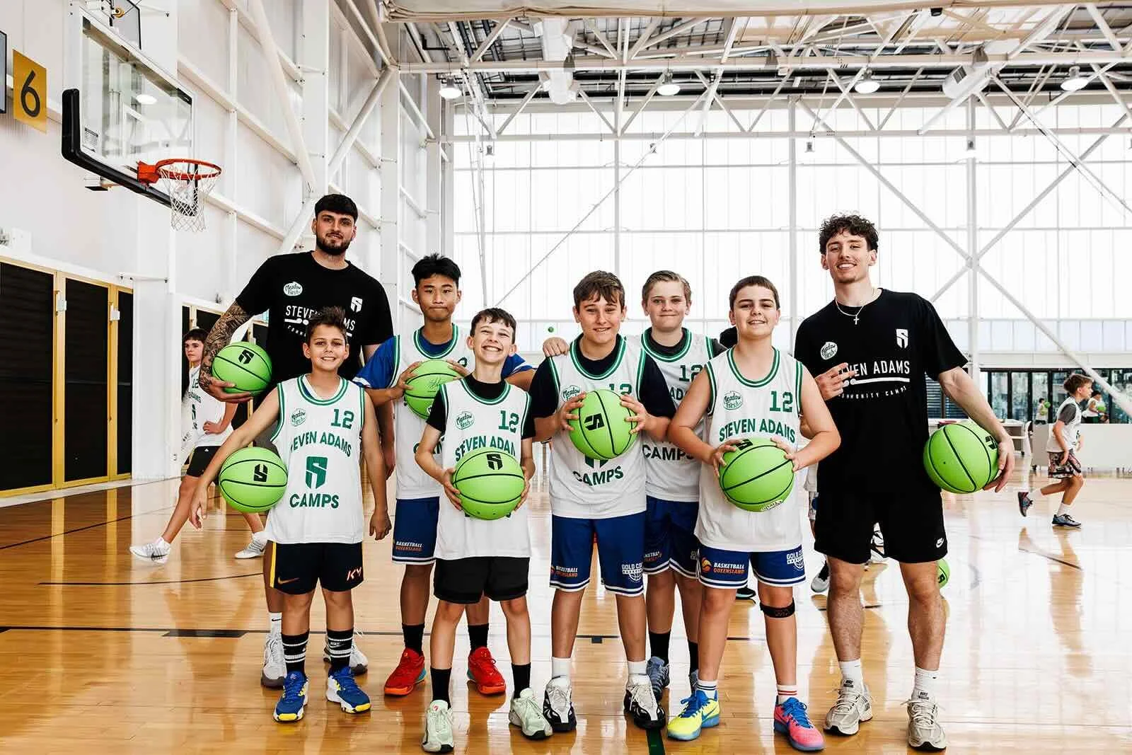 A group of kids from the first ever Steven Adams camp in Australia alongside Coach Michael Afrakoff
