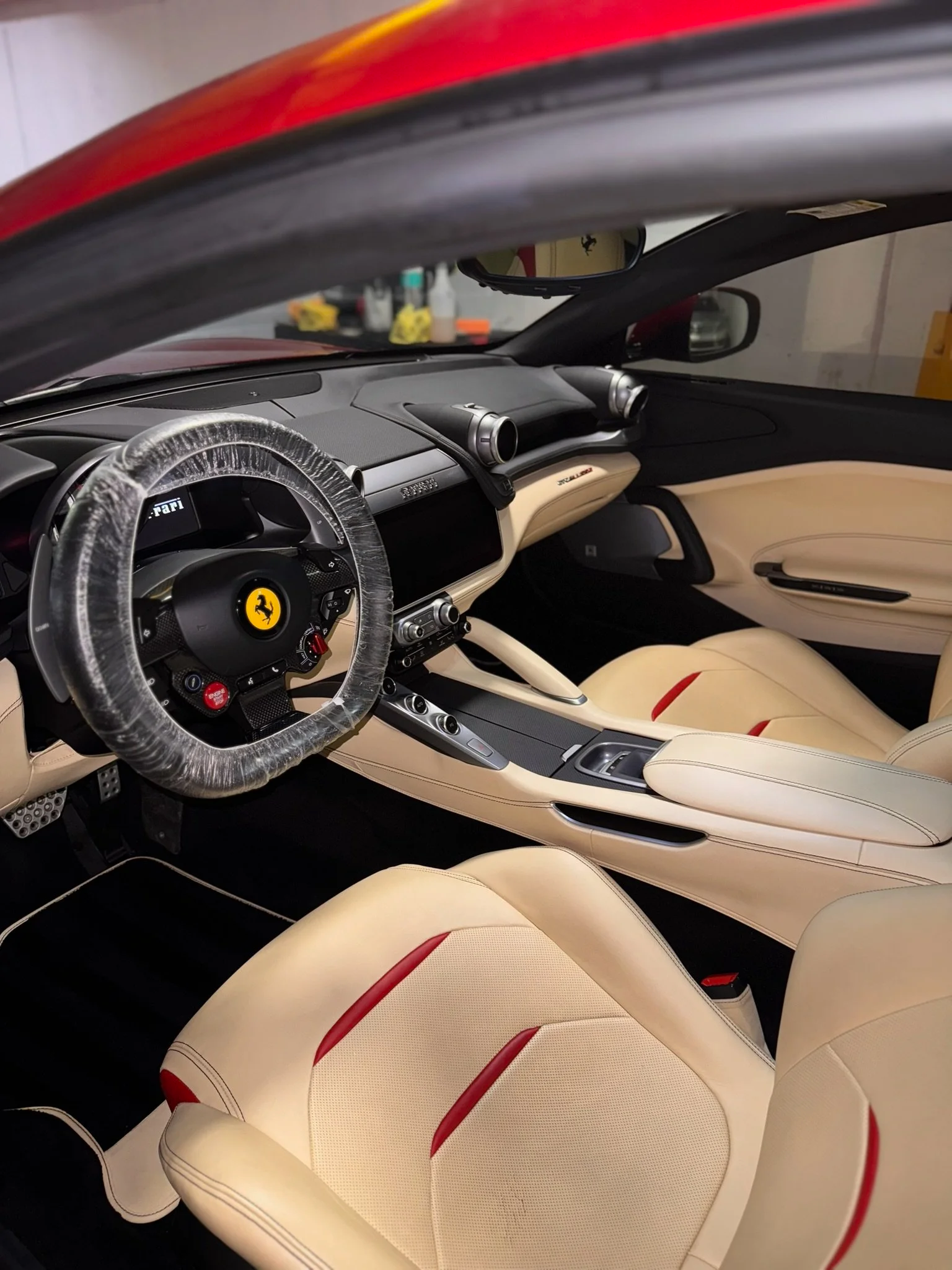 Detailed+Ferrari+interior+with+cream+leather+seats%2C+red+accents%2C+and+clean+dashboard.png