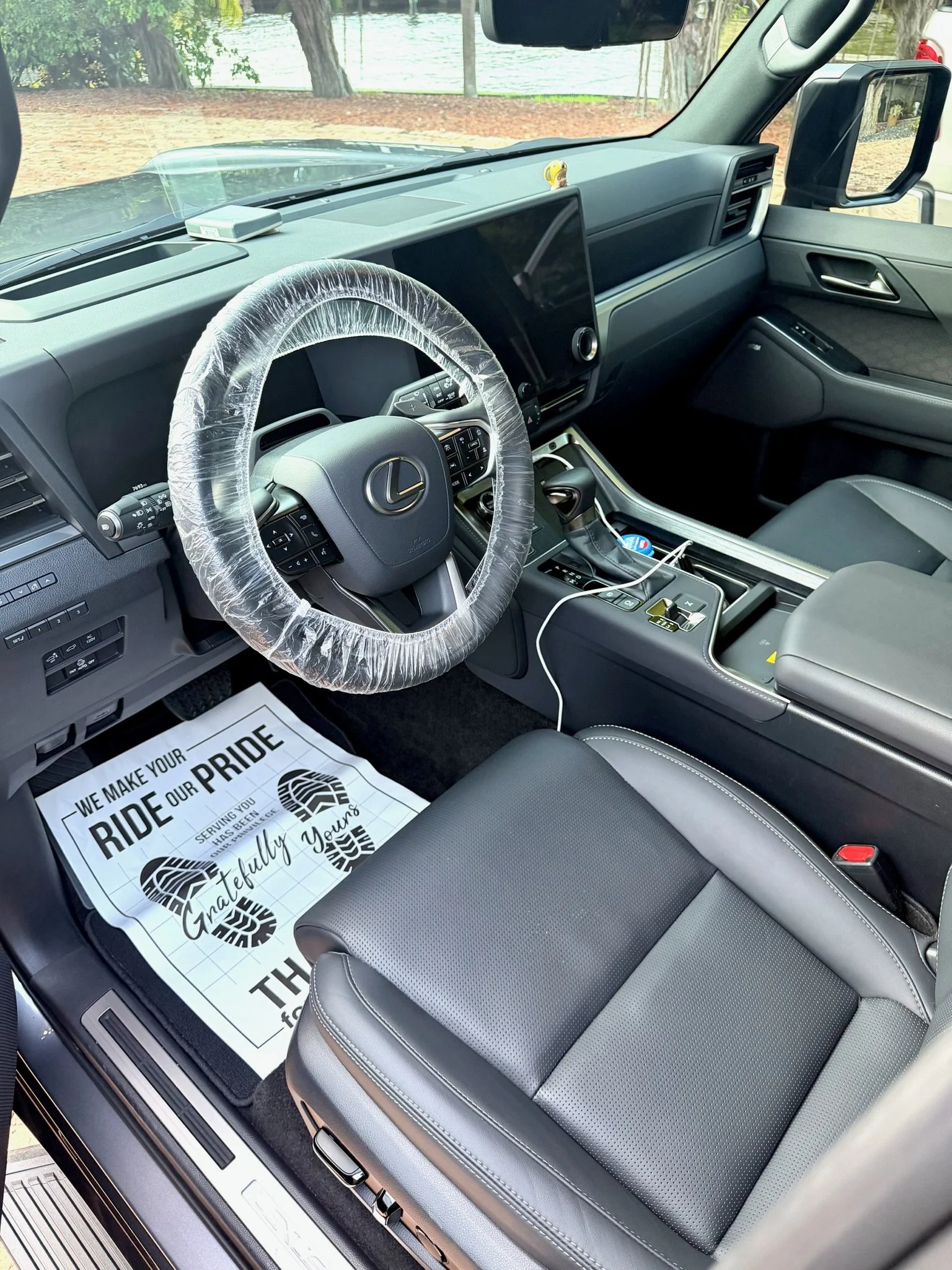 Detailed black Lexus interior with clean leather seats, dashboard, and center console.JPG