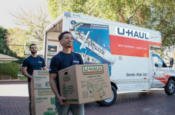 Lamas Moving crew loading a U-Haul moving truck with boxes for a local move in Austin, TX.