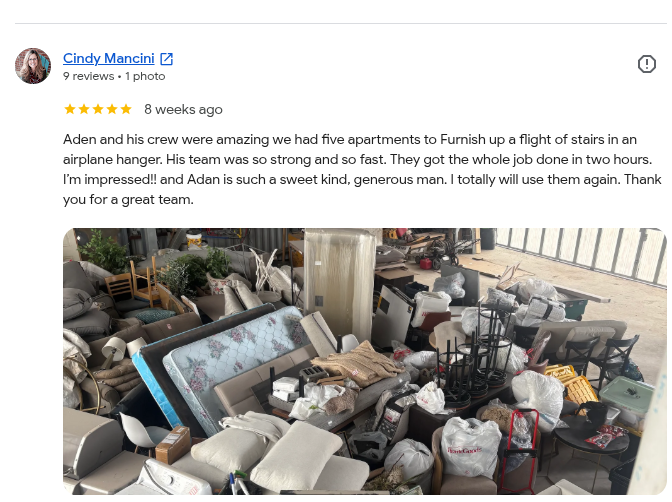 Cluttered storage space with furniture, appliances, and household items