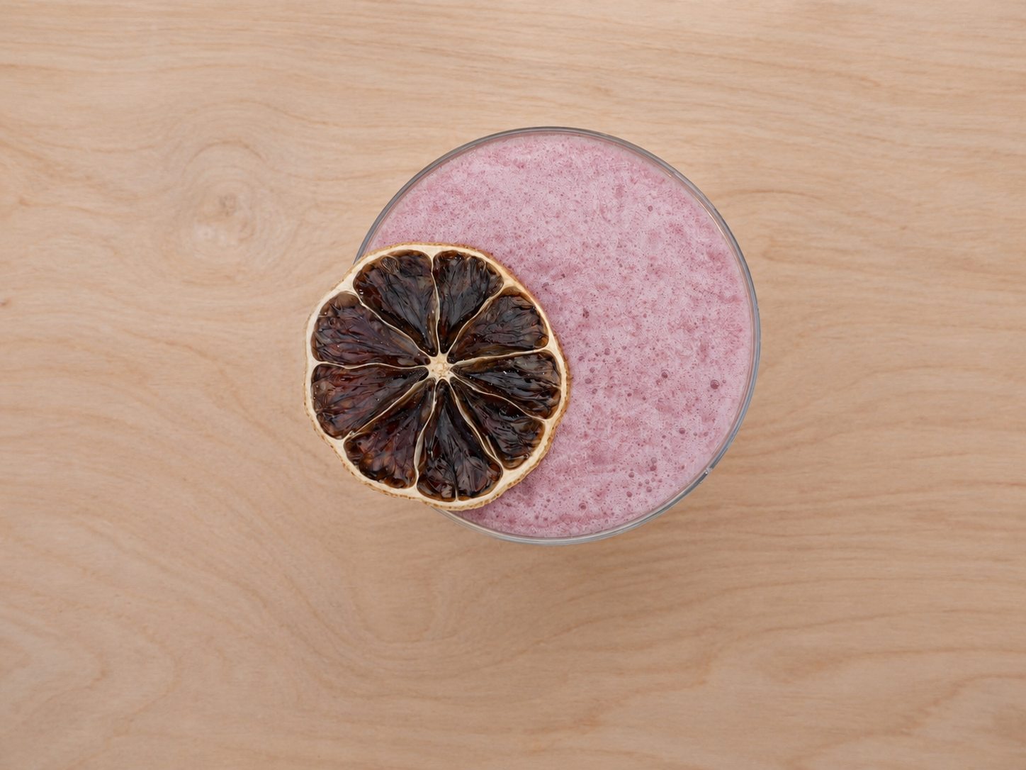Signature handcrafted mocktail with premium garnish served by Sip & Grow Garden.