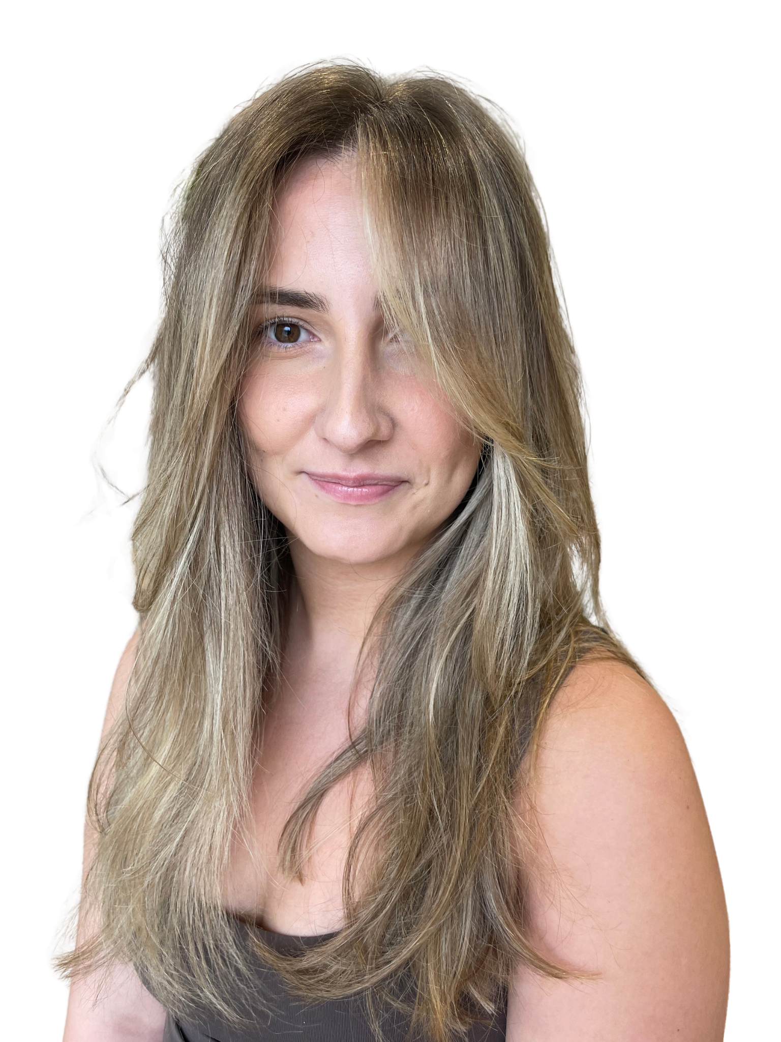 A woman with long, wavy blonde hair and a subtle smile, wearing a black top, against a black background.
